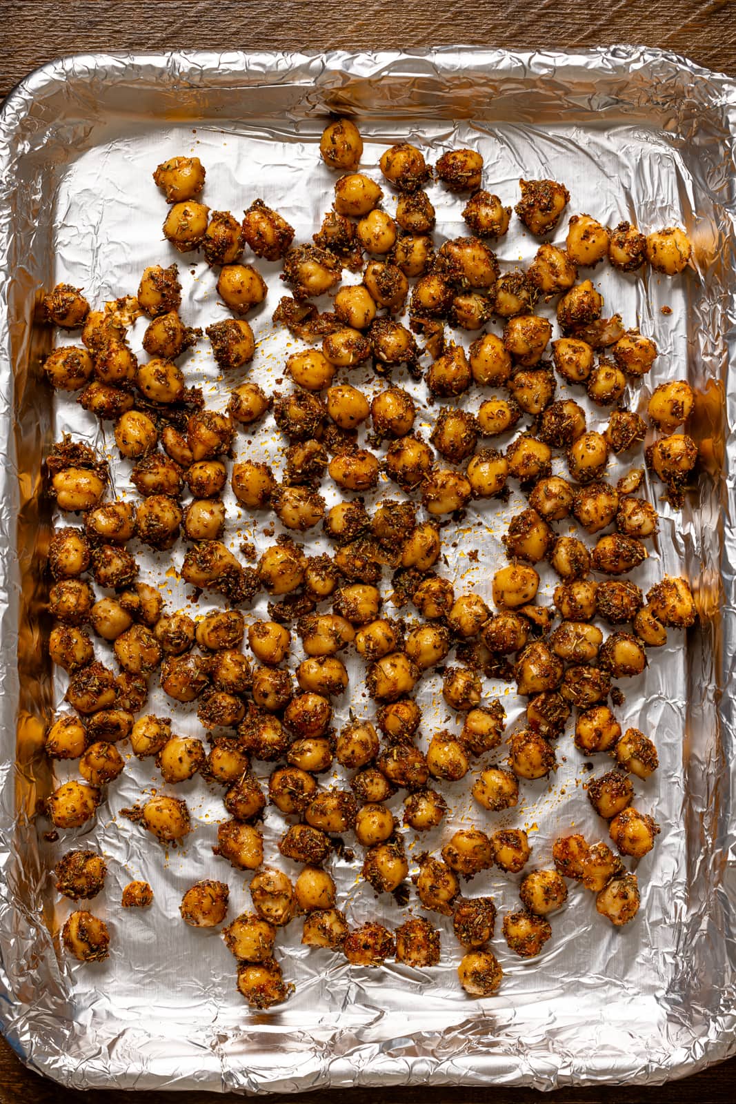 Chickpeas on a baking sheet with foil paper.