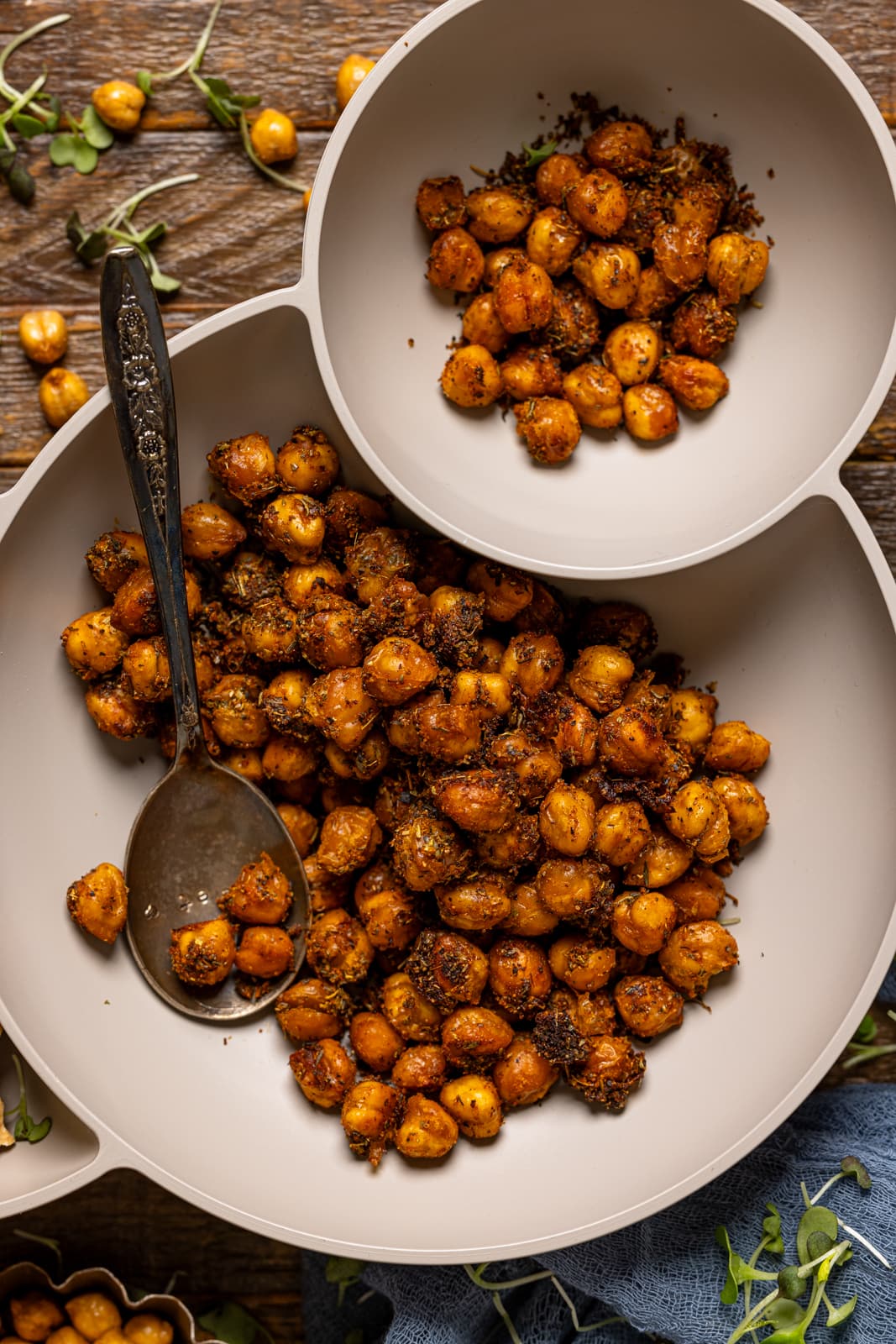 Up close shot of roasted chickpeas in a bowl with a spoon.