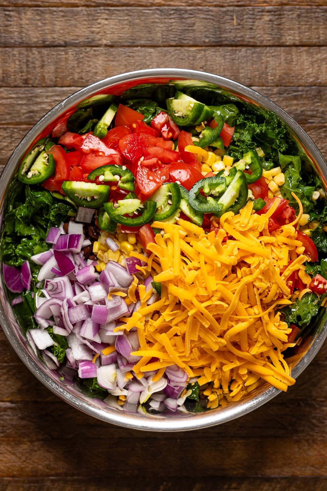 A bowl of all ingredients on a brown wood table.