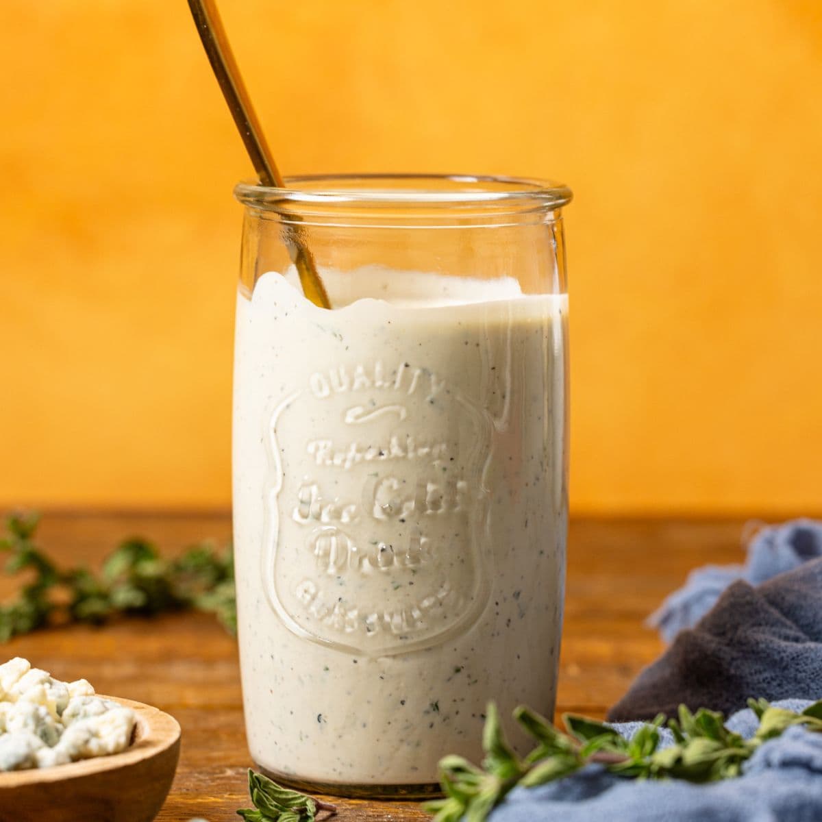 Blue cheese dressing in a mason jar with a spoon.