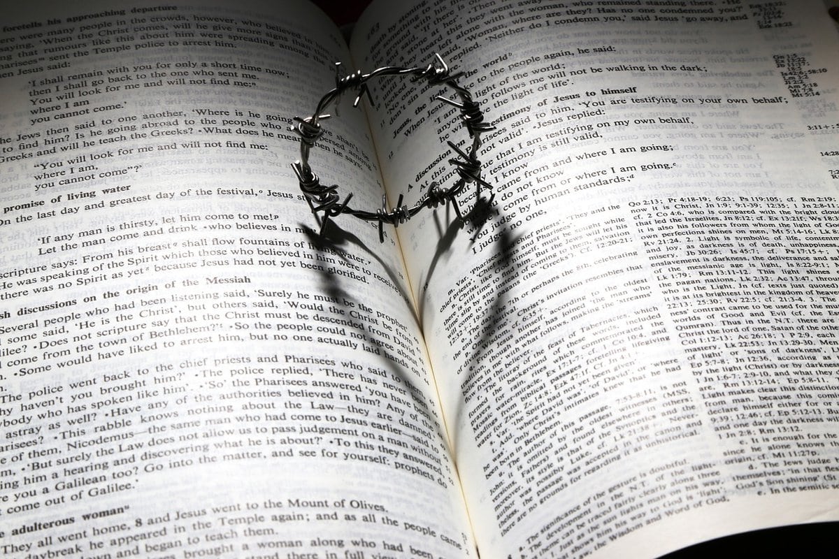 Photo of the bible open with a thorn crown bookmark.