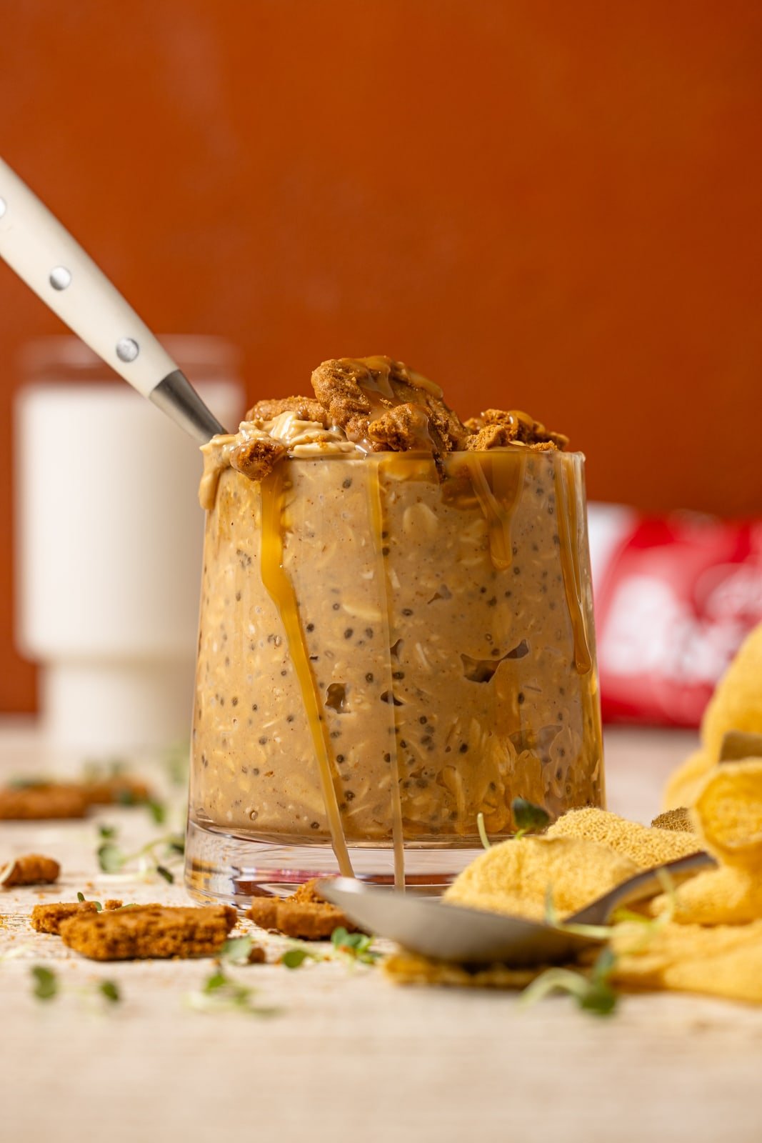 Overnight oats with a spoon and biscoff cookies as garnish.