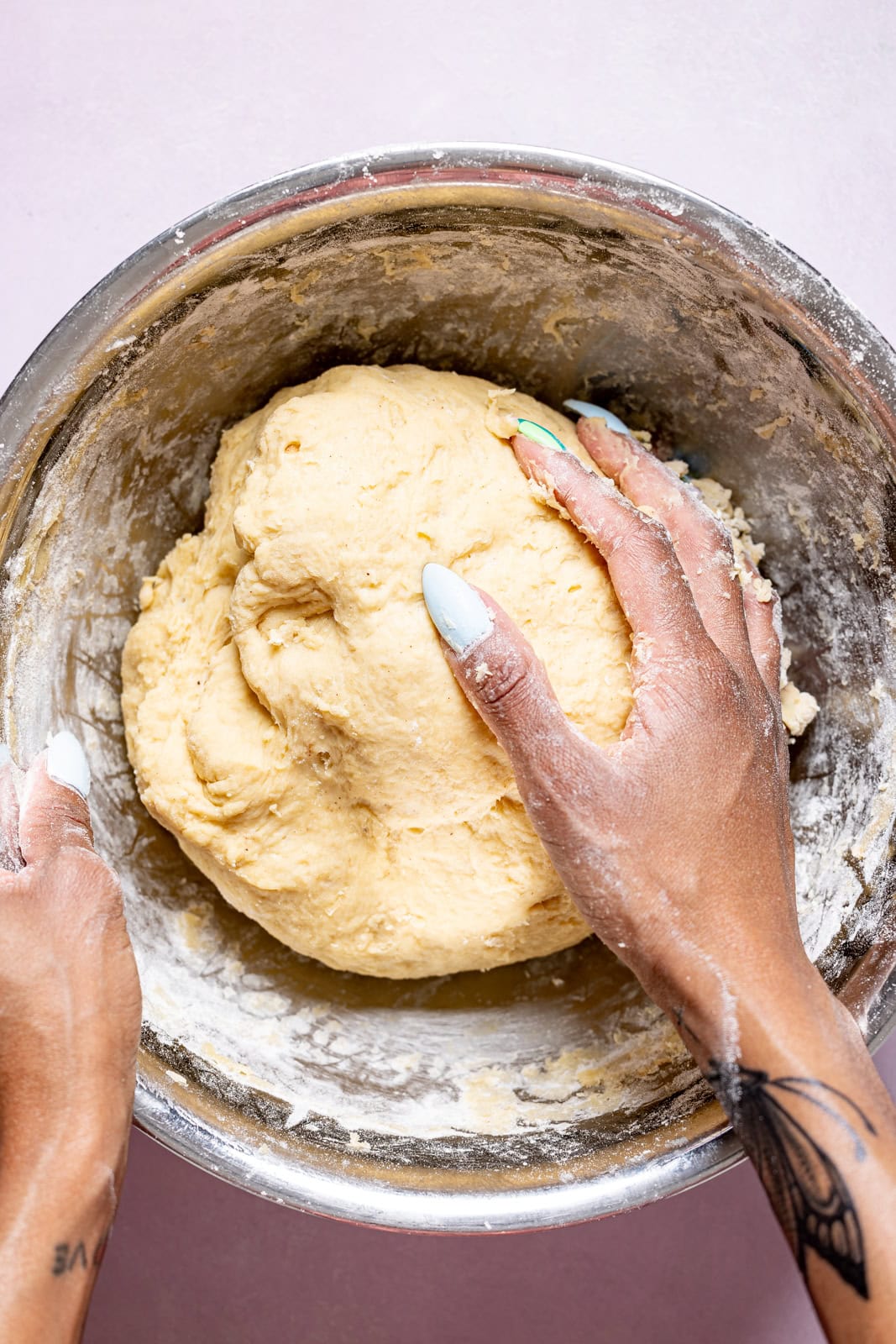 Dough being kneaded in a bowl.