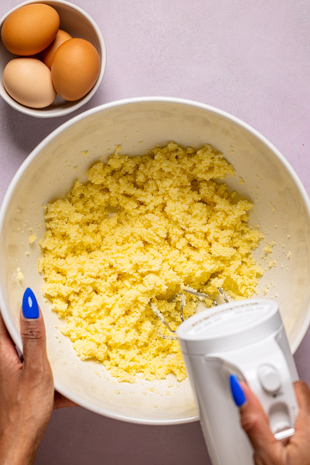 Ingredients being mixed in a bowl with a hand mixer.