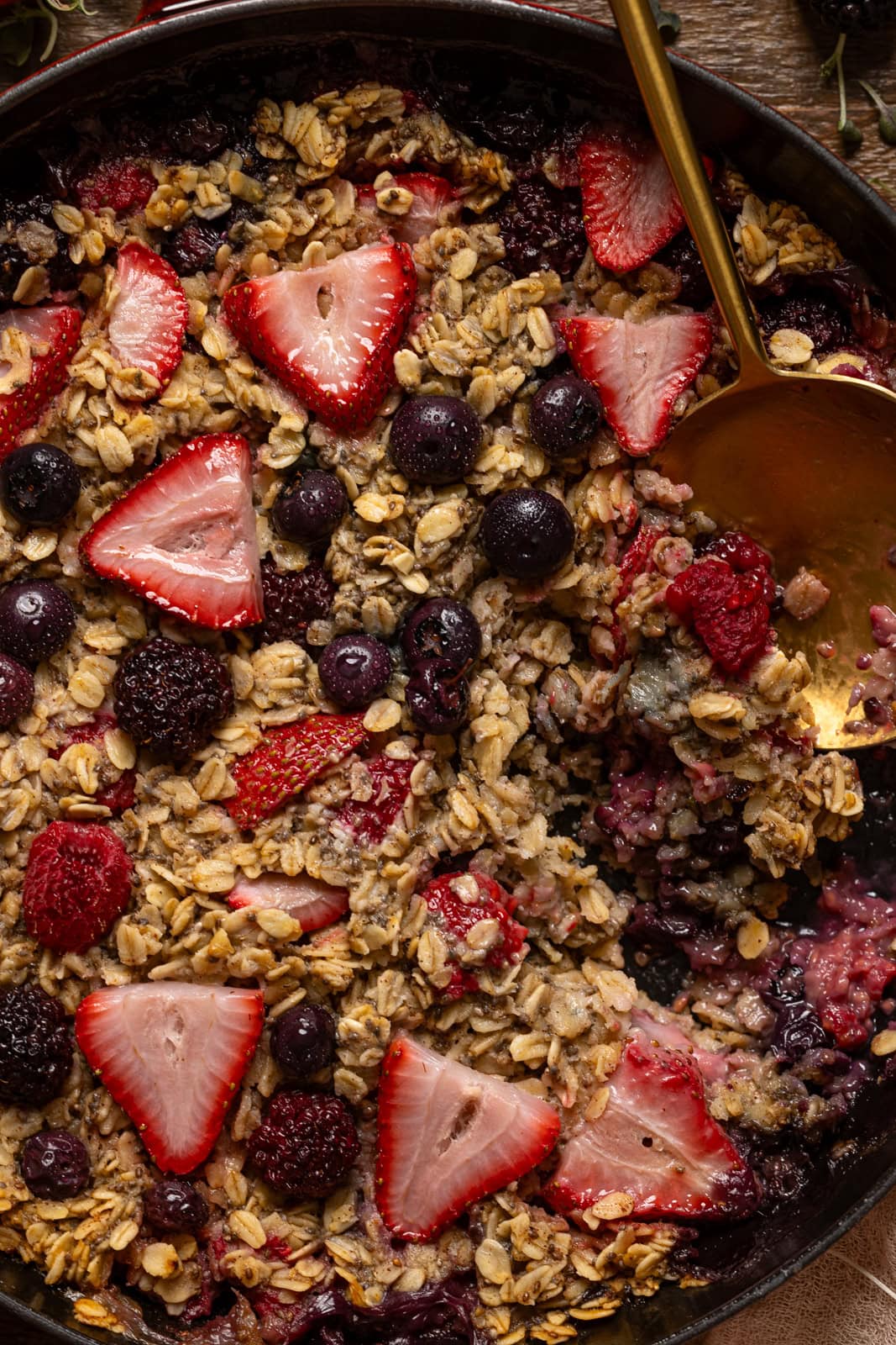 Up close shot of baked oatmeal with a gold spoon.