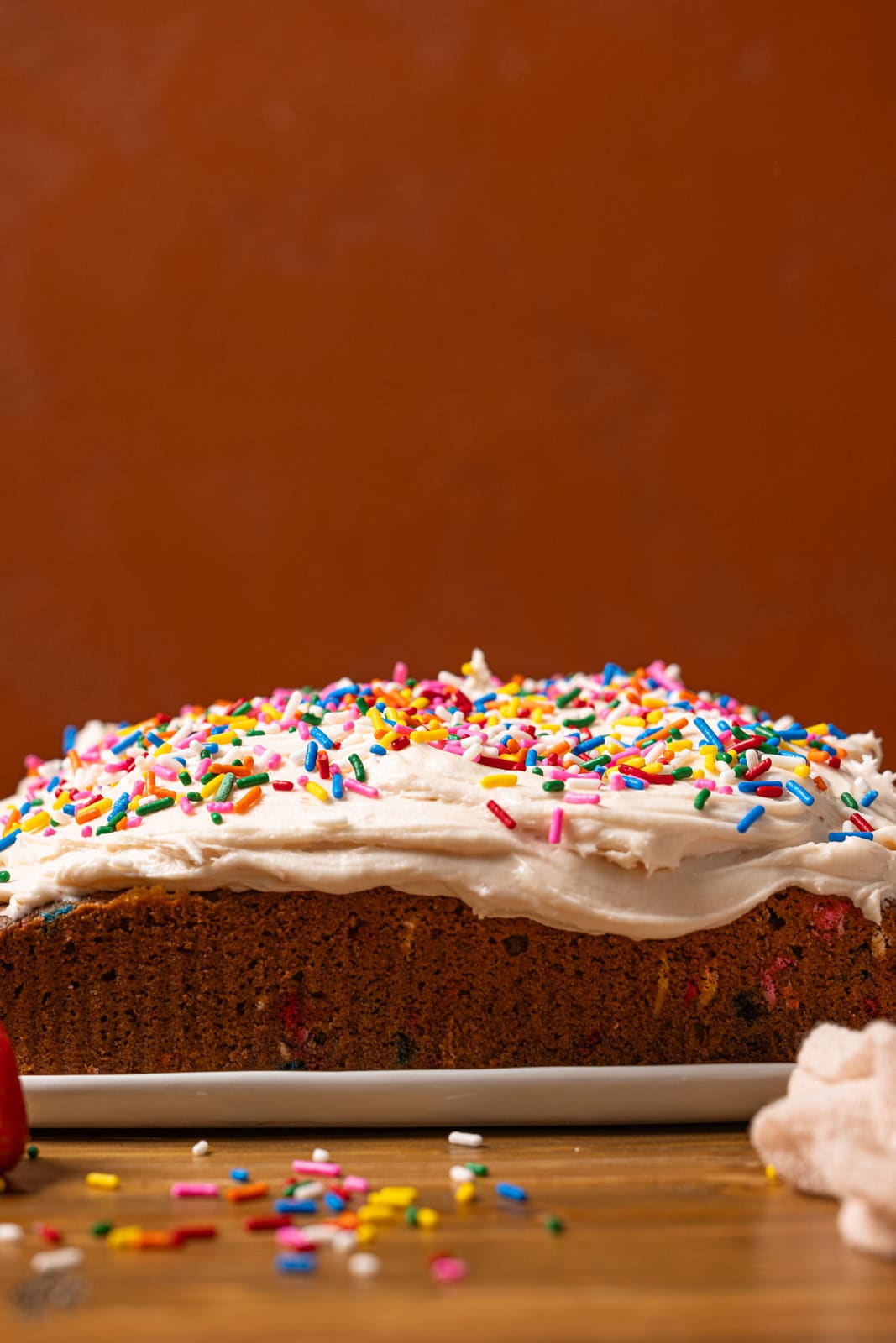 Frosted cake with rainbow sprinkles. 