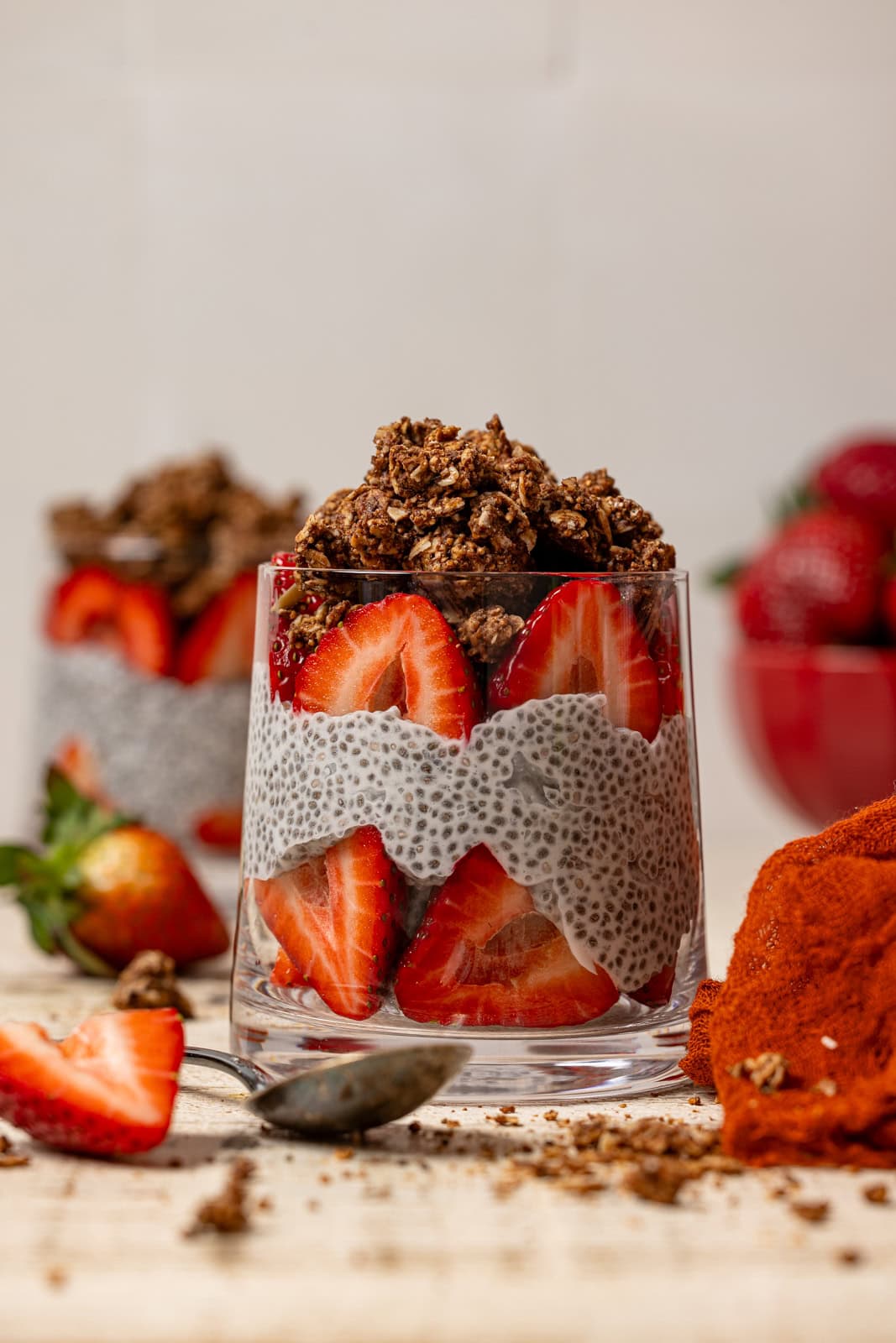 Two glasses with chia pudding and strawberries. 