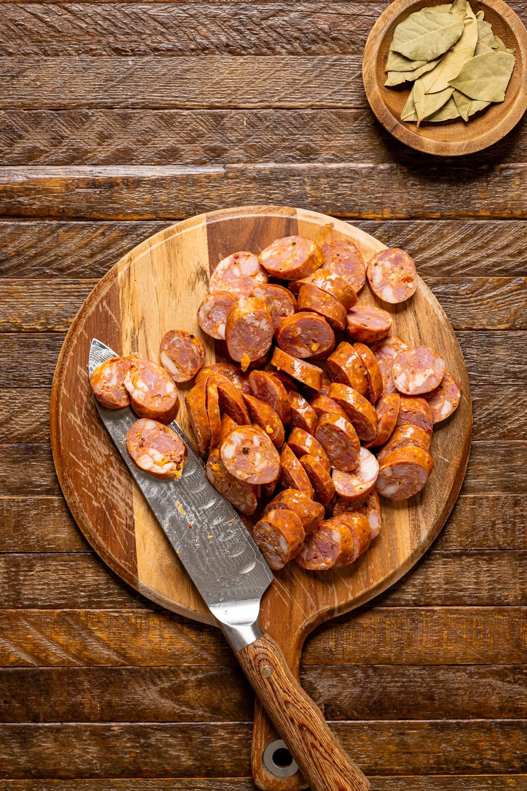Sliced sausages on a cutting board with a knife.