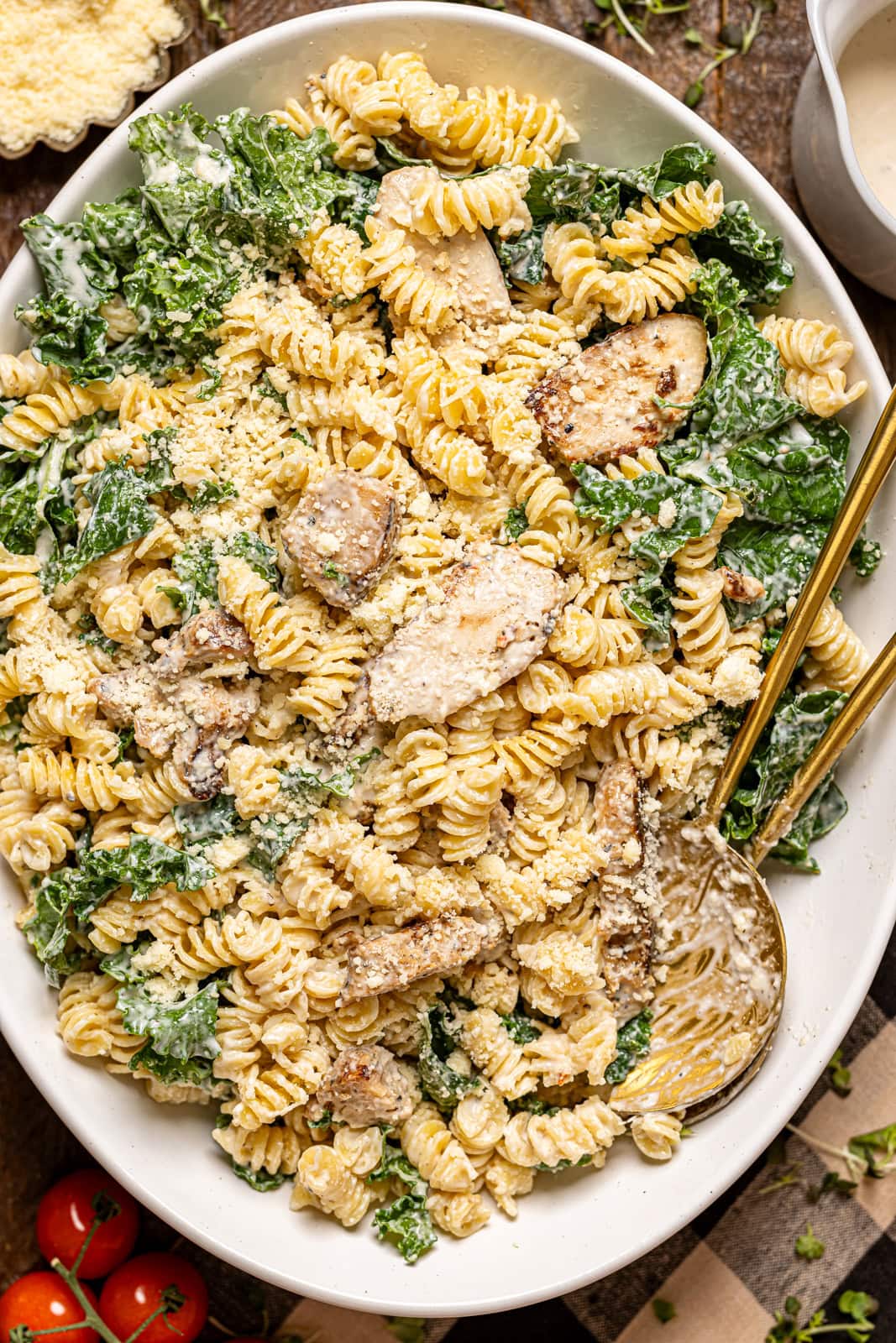 Chicken pasta salad on a platter with two spoons.