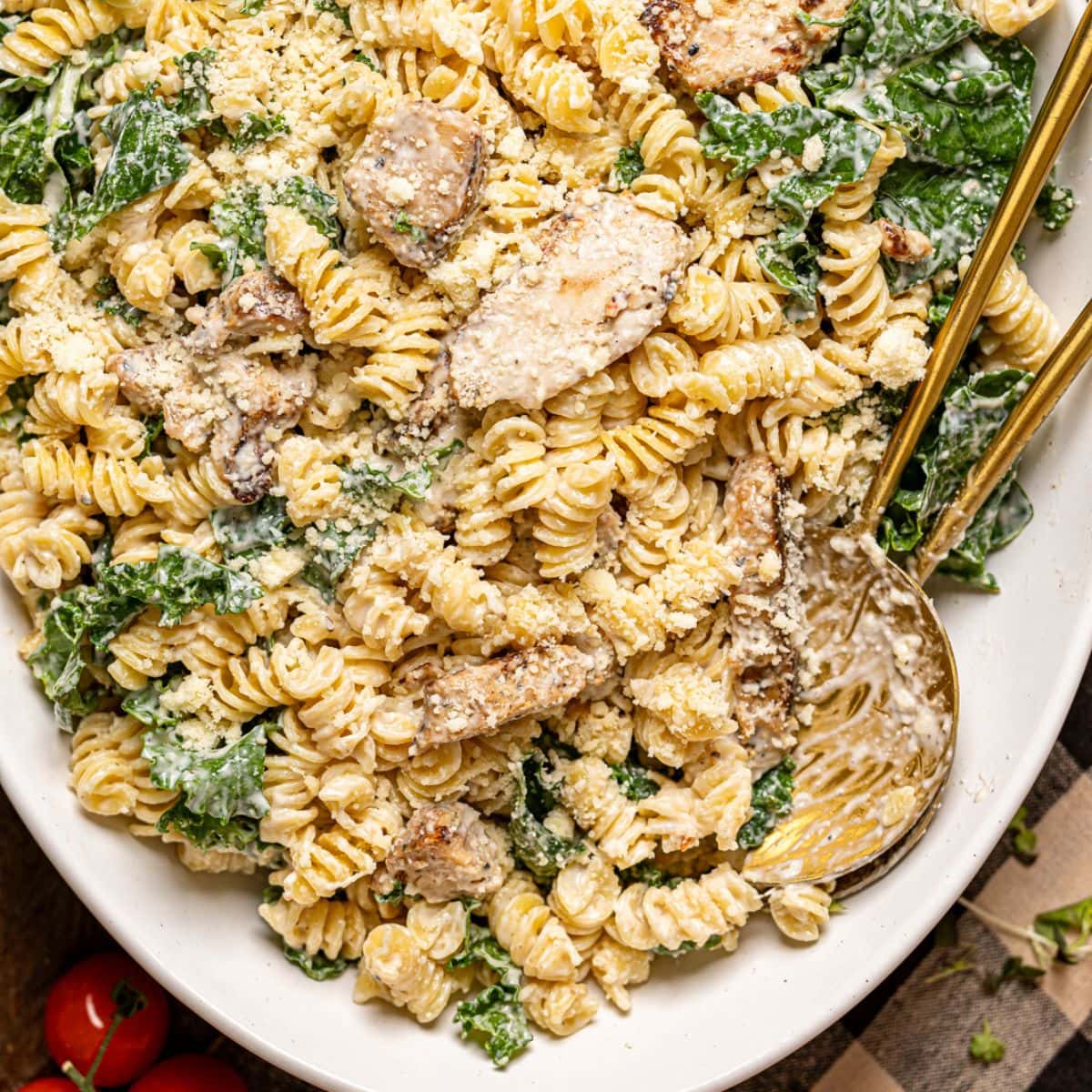 Chicken pasta salad on a platter with two spoons.