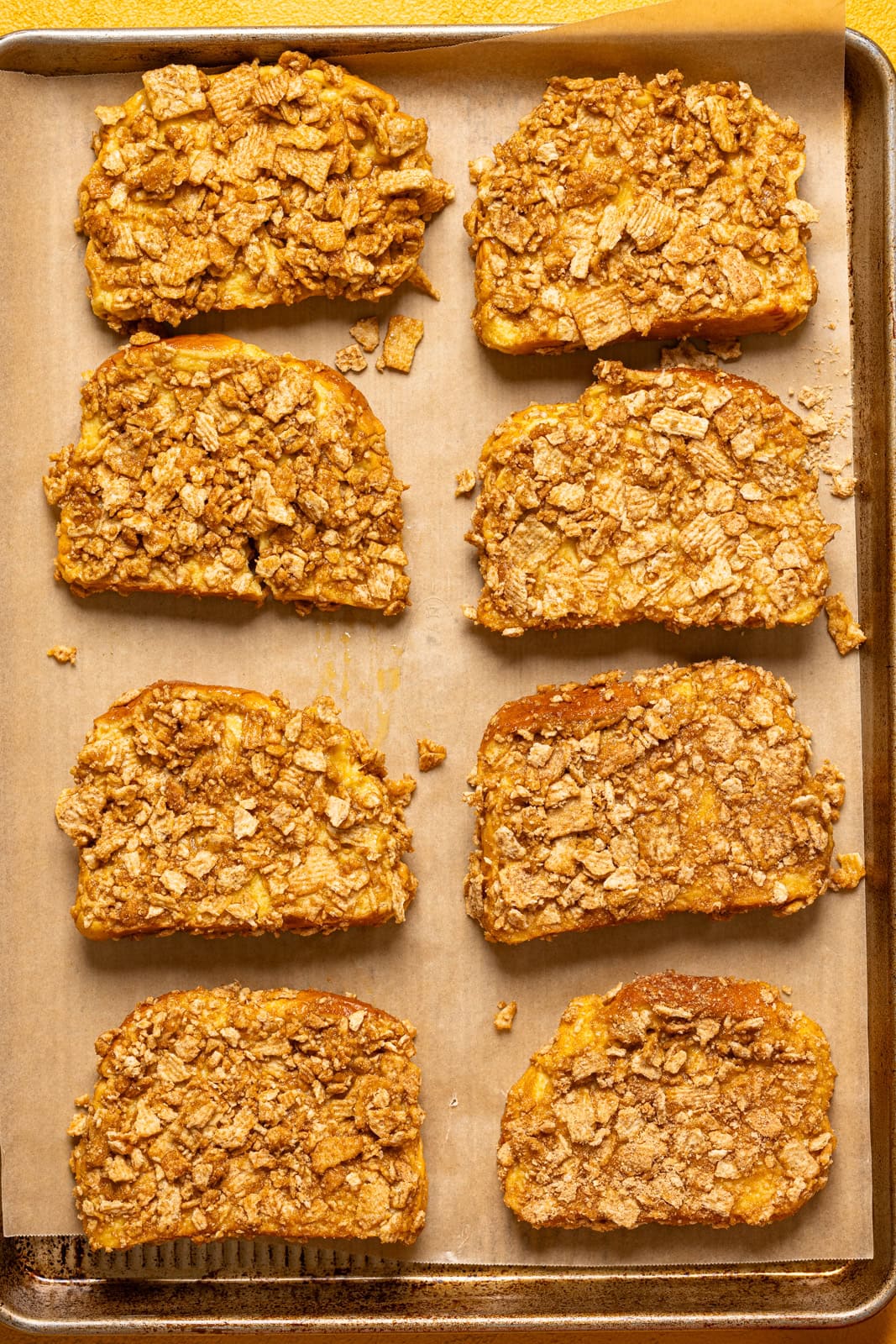French toast lined on a baking sheet with parchment paper.