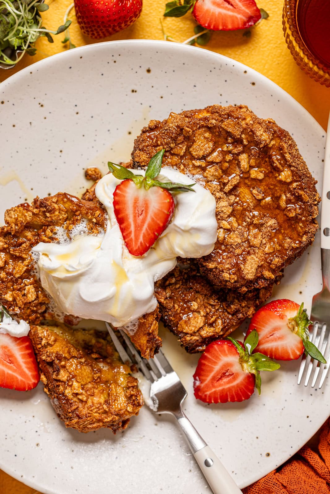 Up close shot of french toast on a plate with two forks.