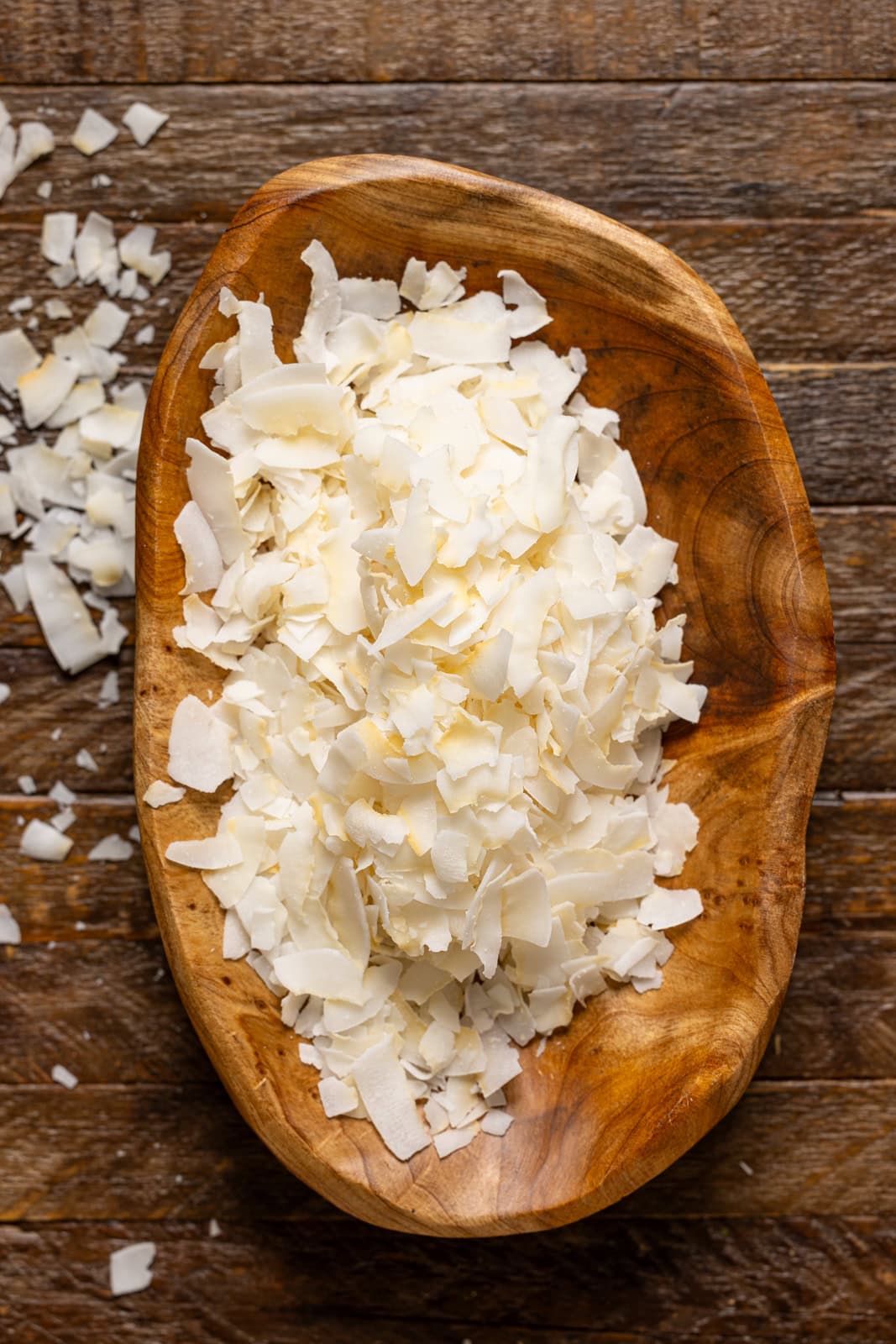 Coconut flakes in a wood bowl.
