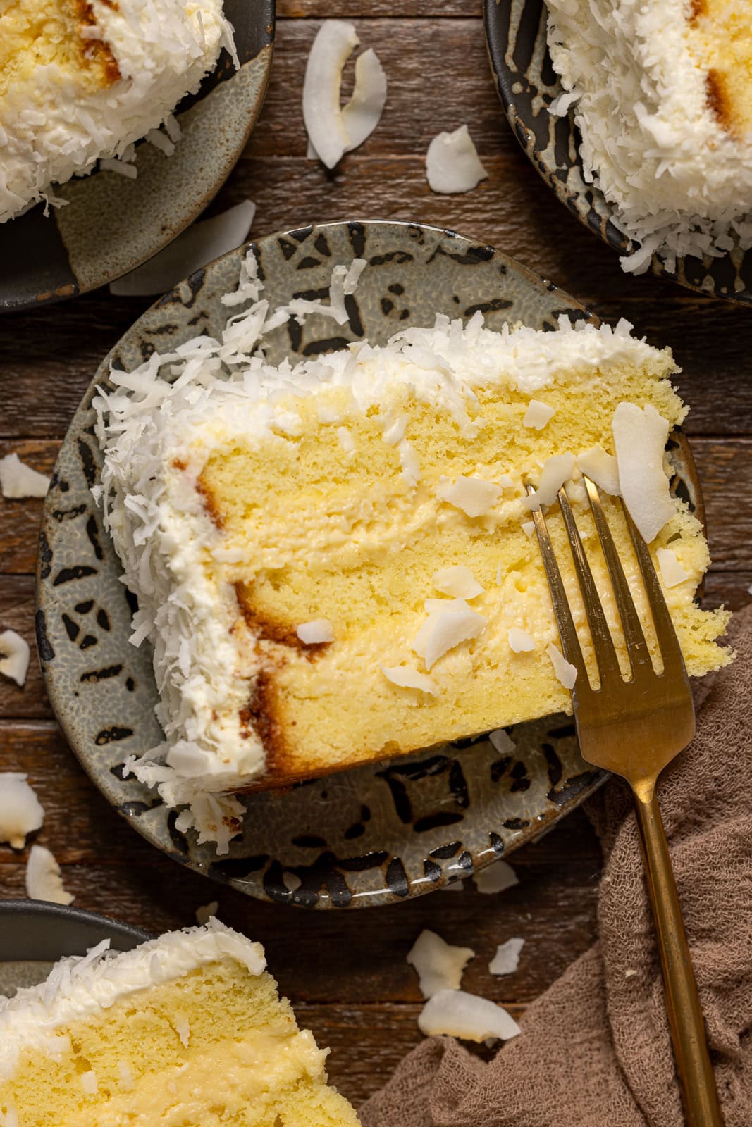 Up close shot of coconut rum cake on a plate with a fork.