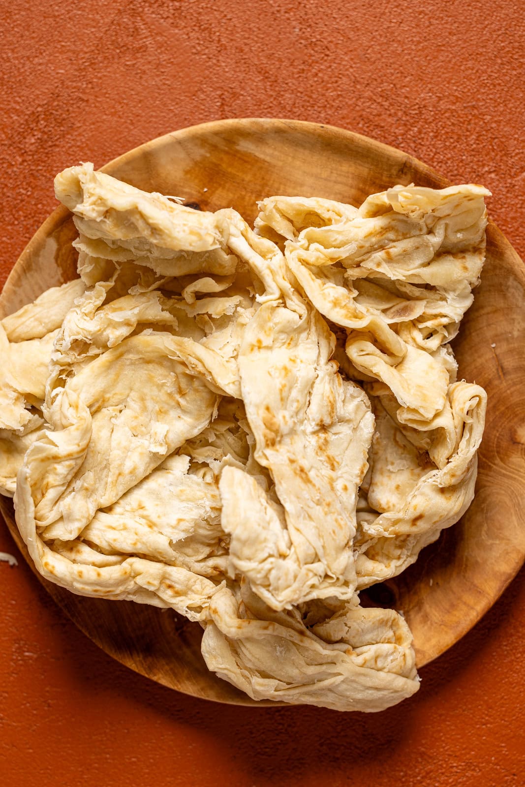 Roti skin on a wood plate.