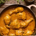 Up close shot of chicken in a white pot.