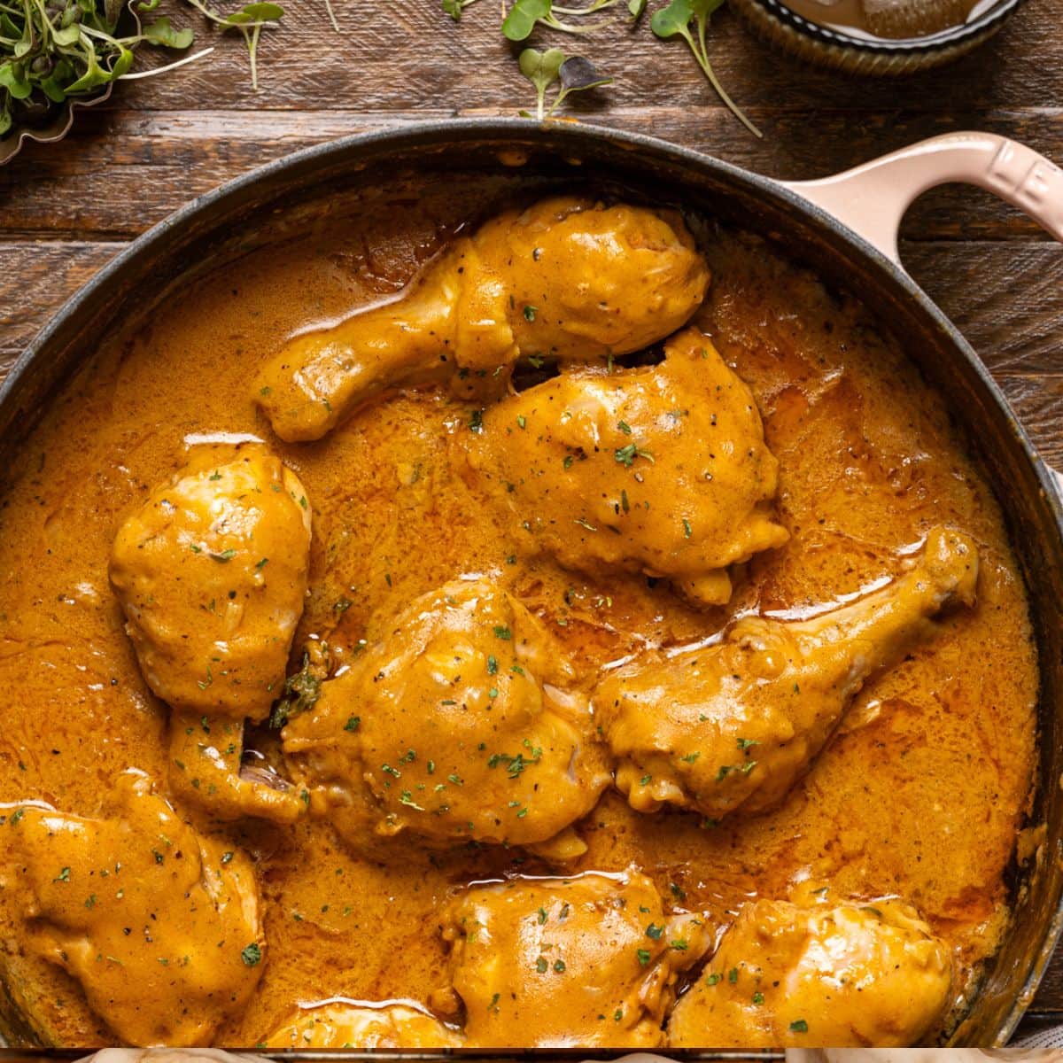 Up close shot of chicken in a white pot.