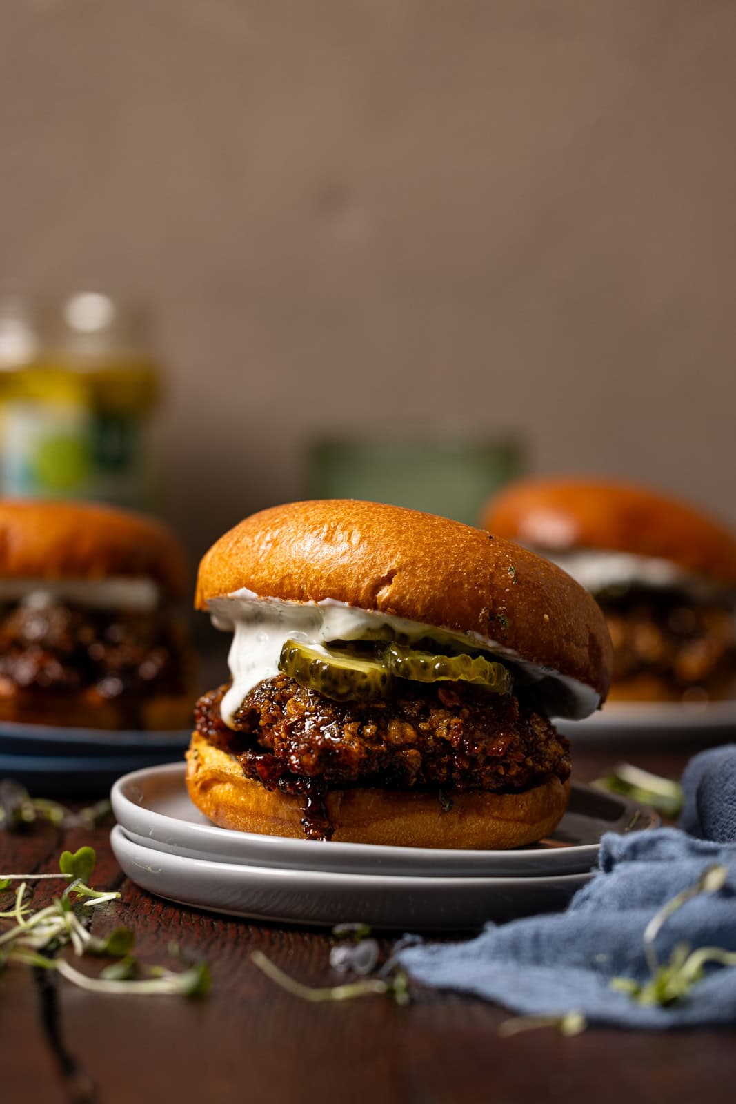 Hot honey chicken sandwiches on a brown wood table.