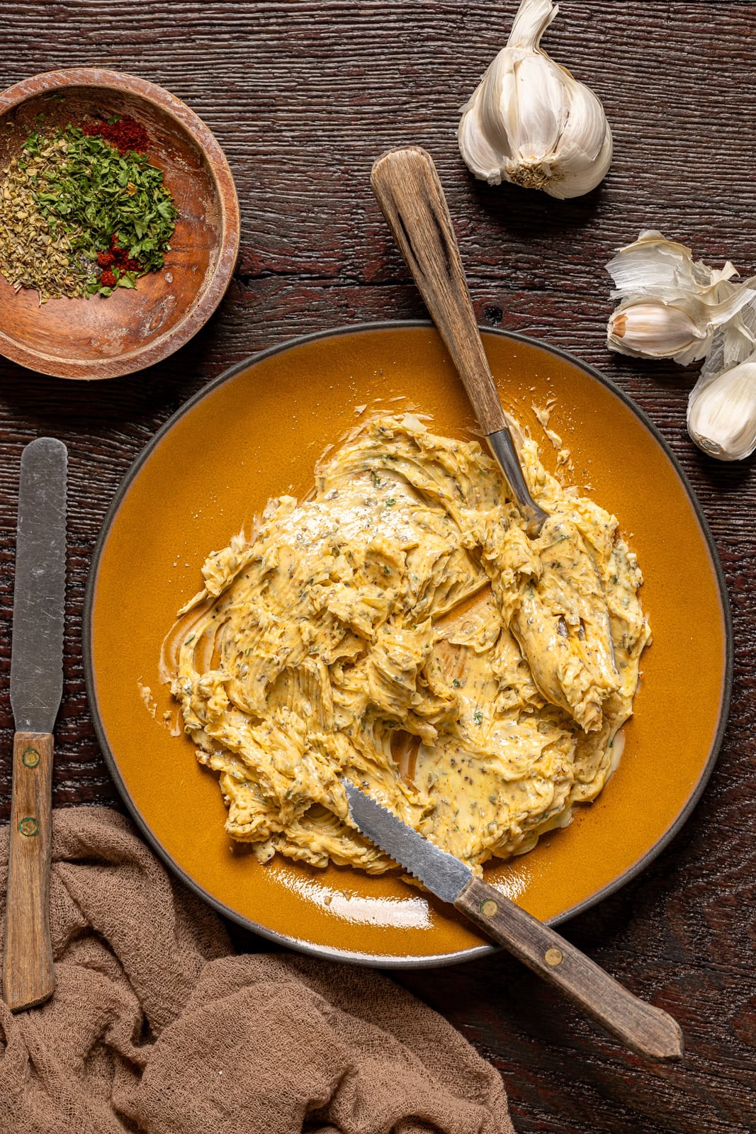 Plate with your herb butter with knives and garlic.