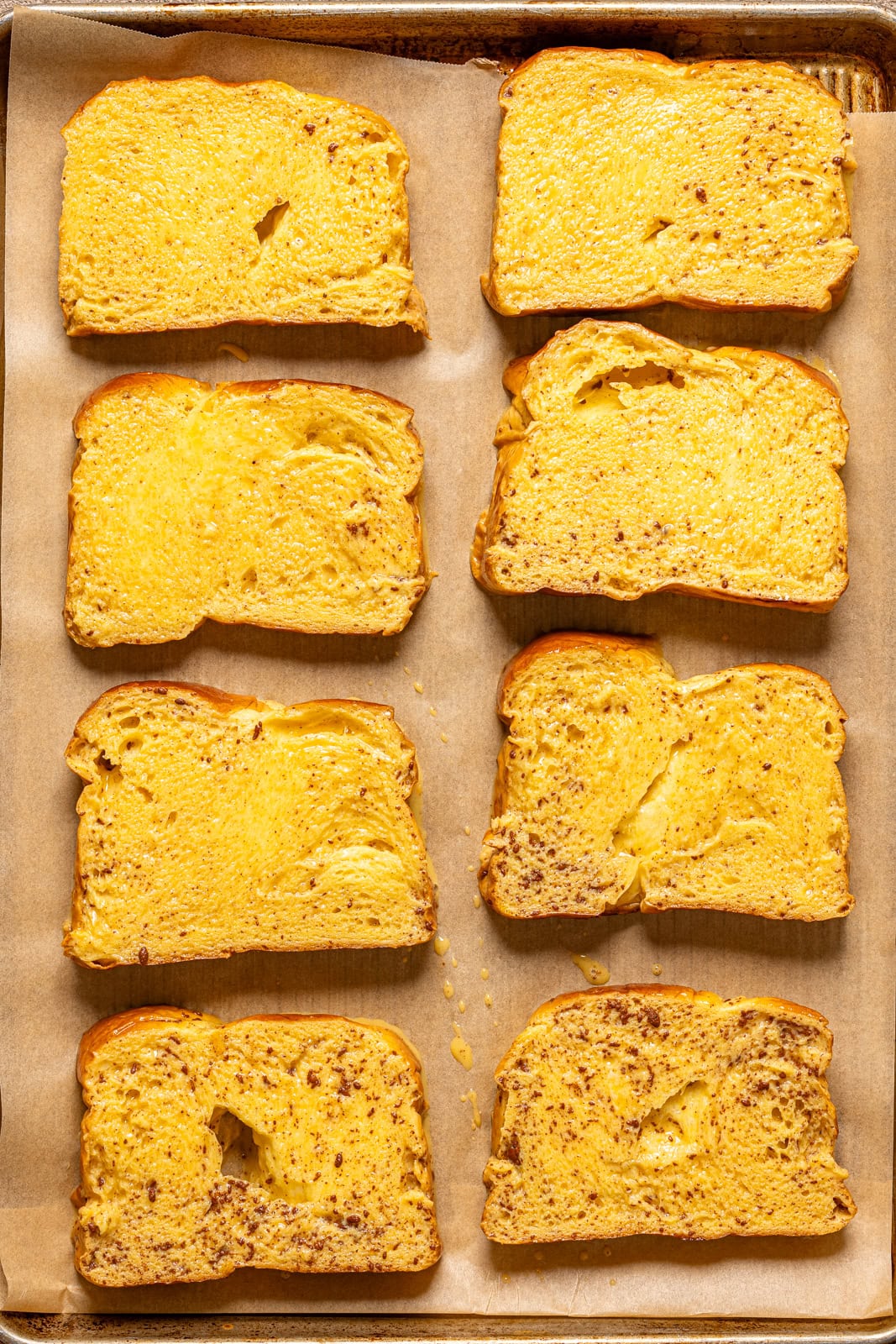 French toast on a baking sheet with parchment paper. 