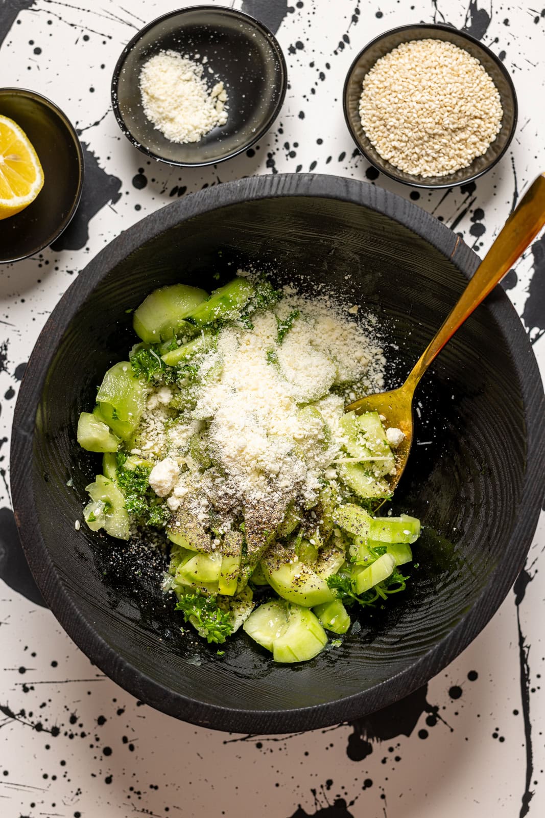 All ingredients together in a black bowl with a spoon.