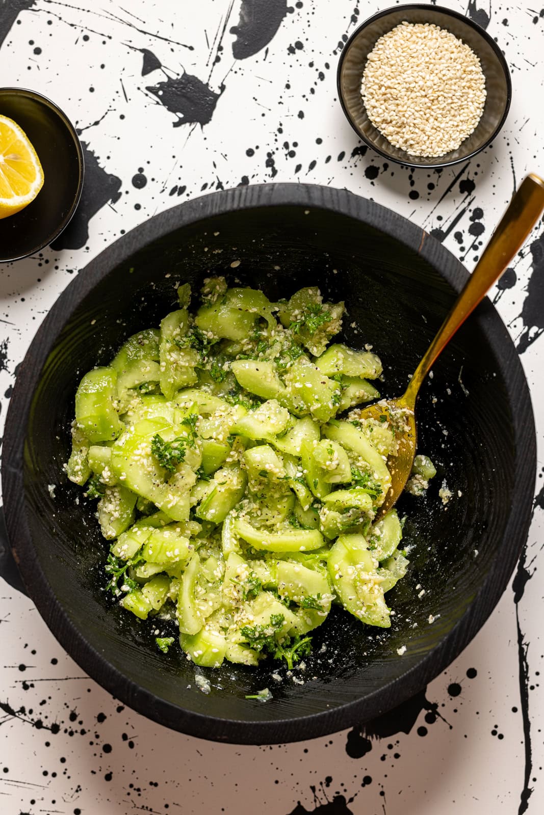 Ingredients stirred together in a black bowl with a spoon.