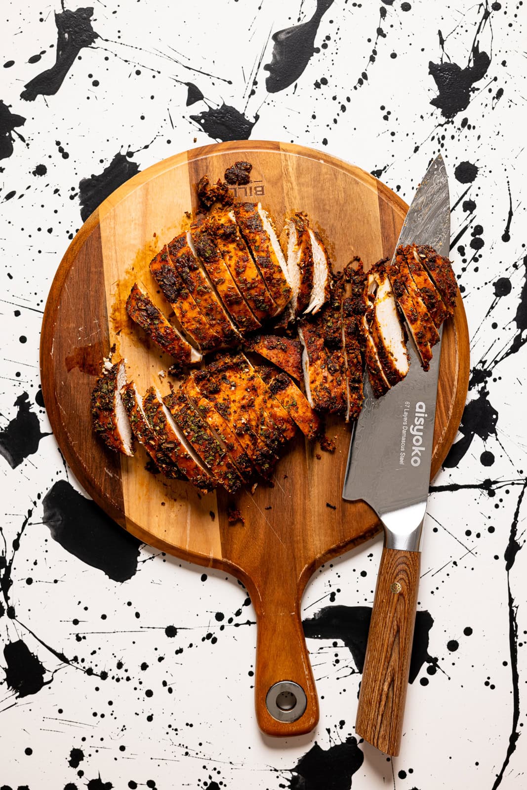 Chopped cooked chicken on a cutting board with a knife.