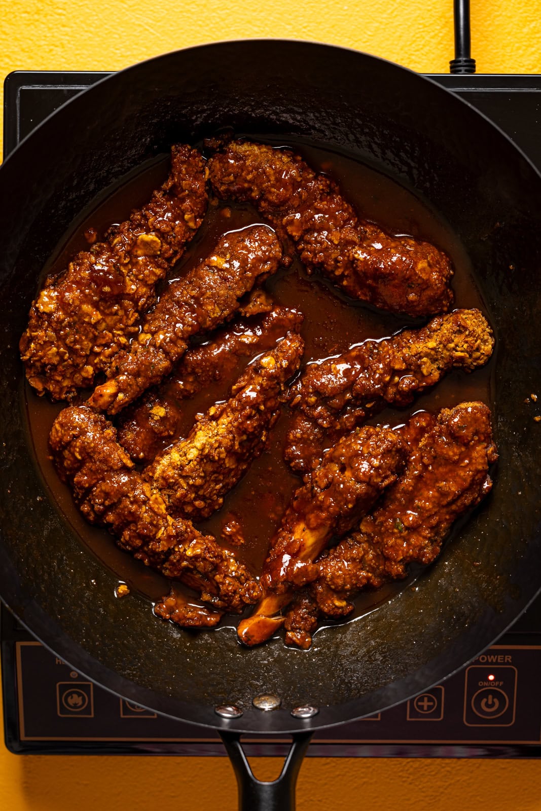 BBQ chicken tenders in a wok.