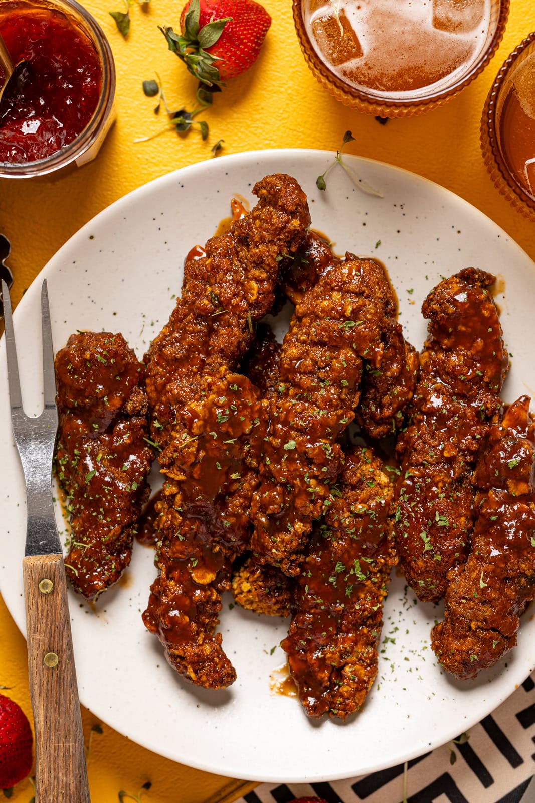 BBQ chicken tenders on a plate with a fork.