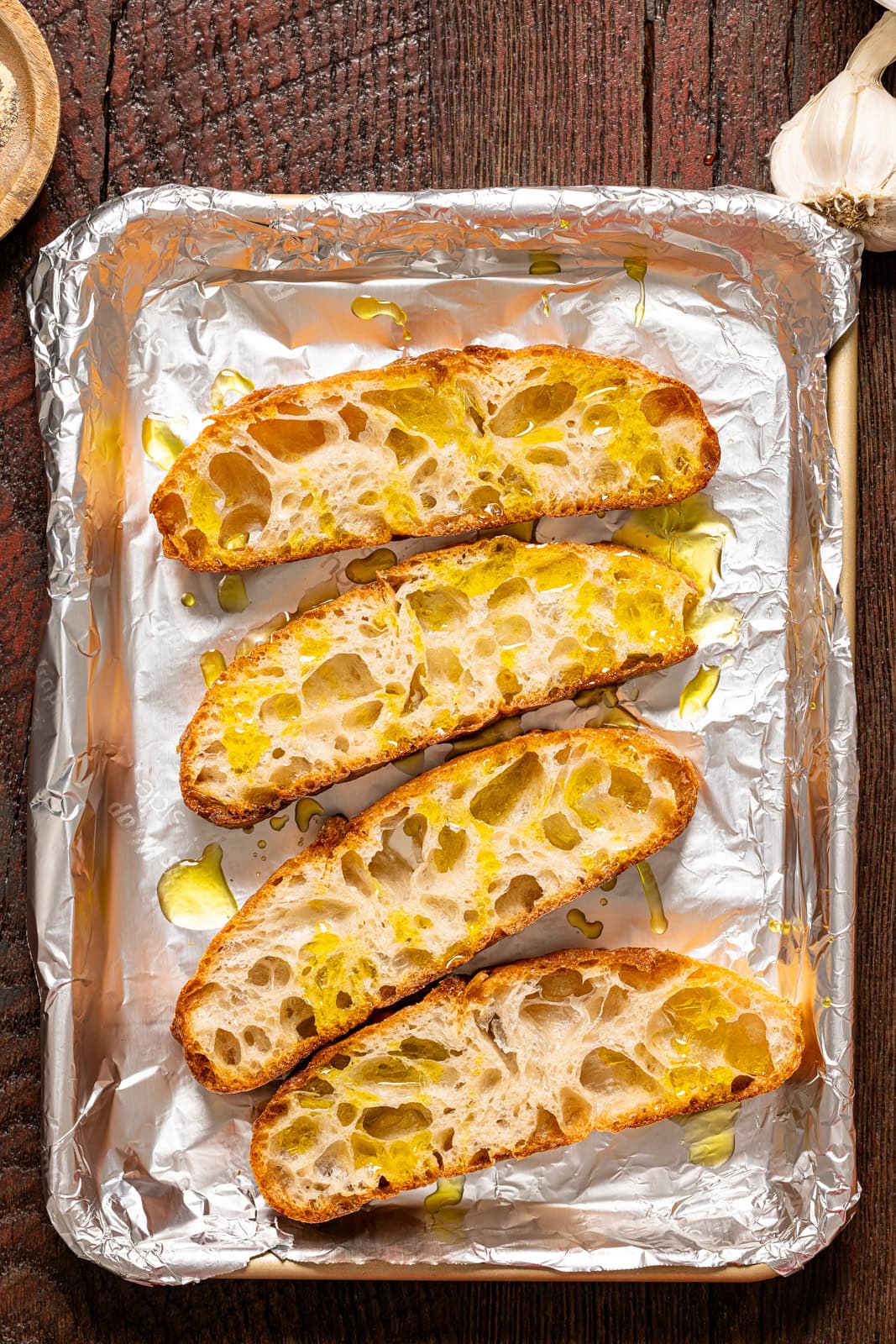 Sliced bread on a baking sheet with foil.