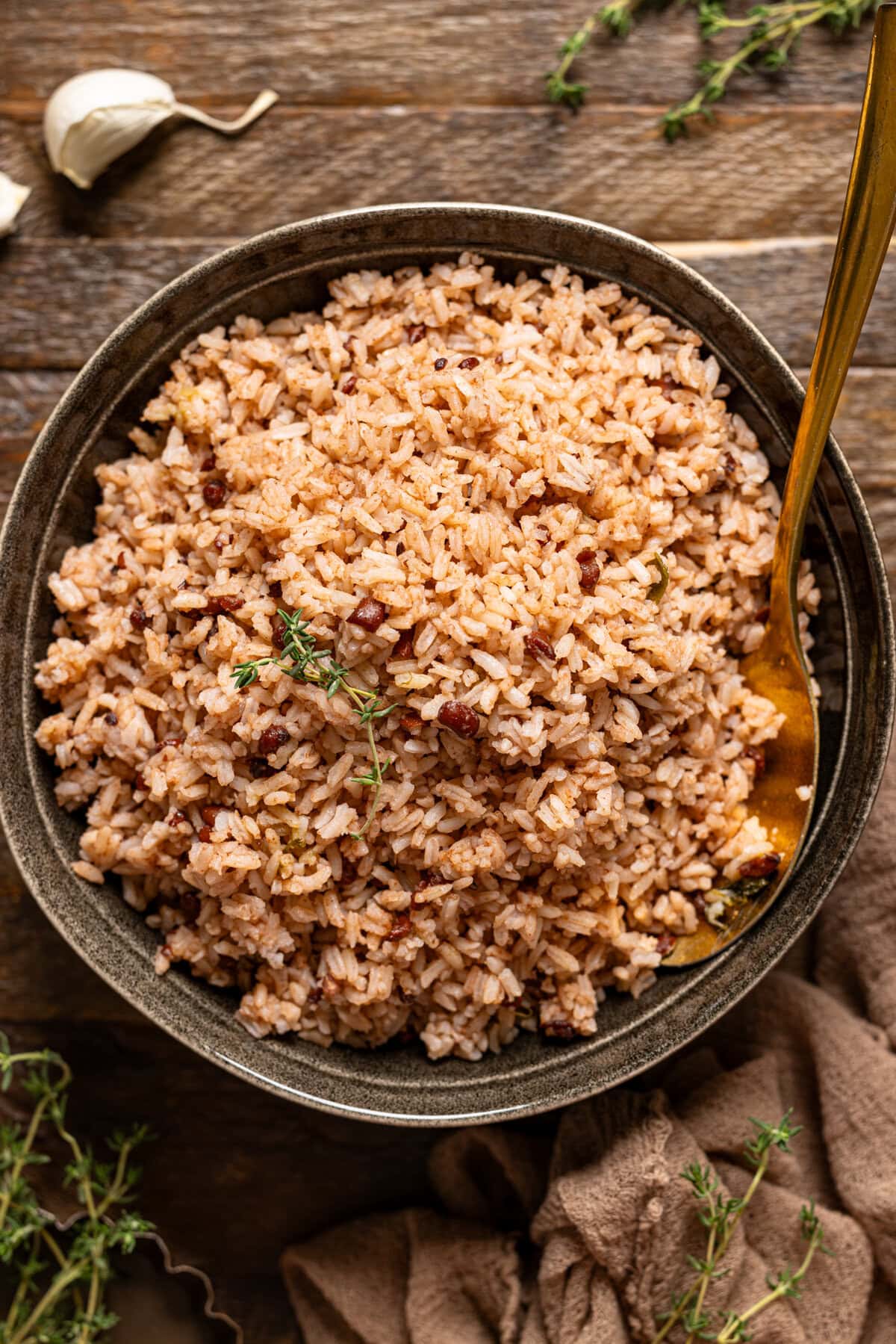 Rice and peas in a bowl on brown wood table.