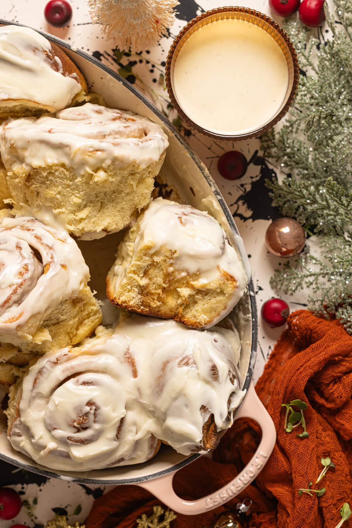 Up close shot of Eggnog cinnamon rolls in a baking dish.