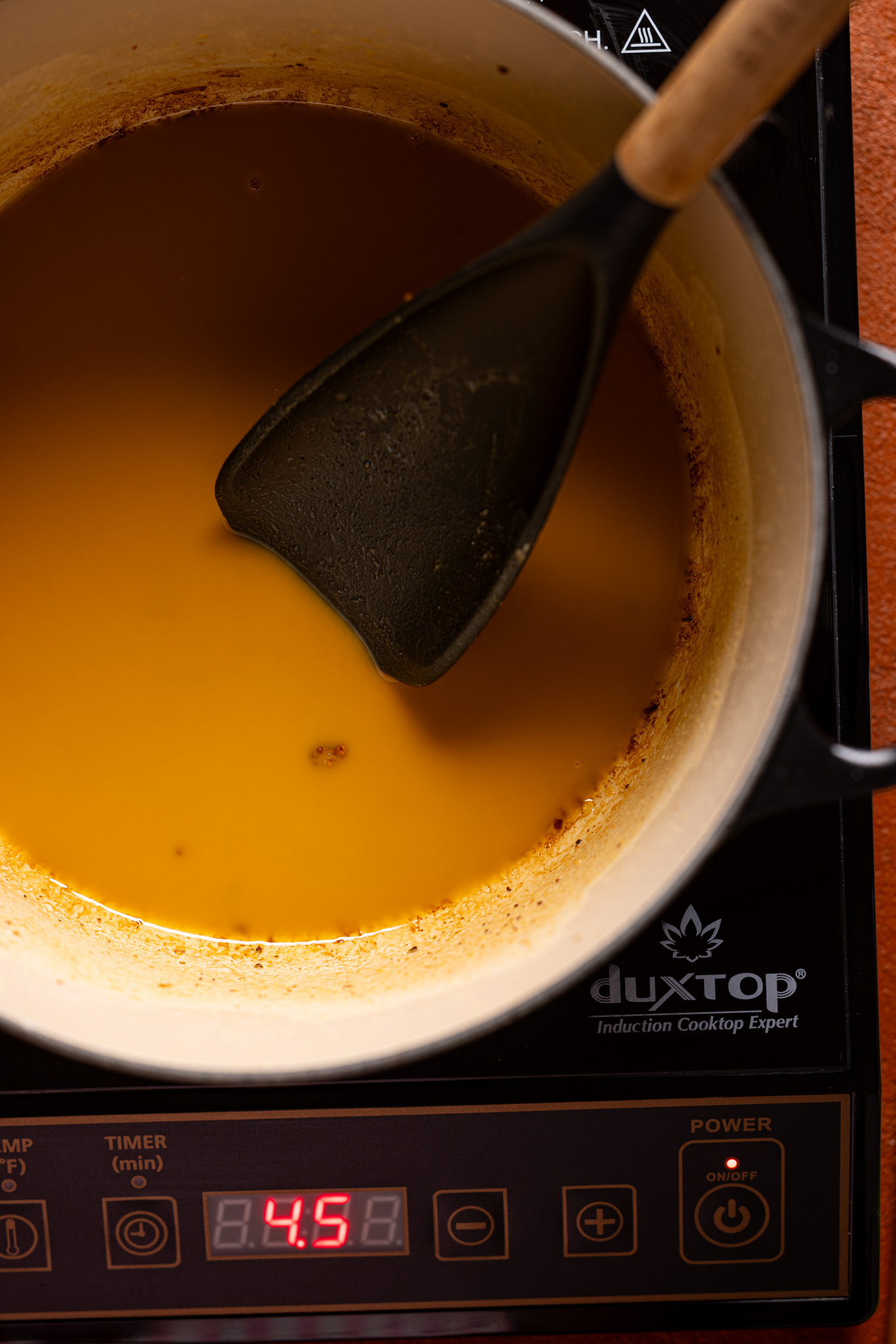 Image of cooked roux in a pot with a spoon.