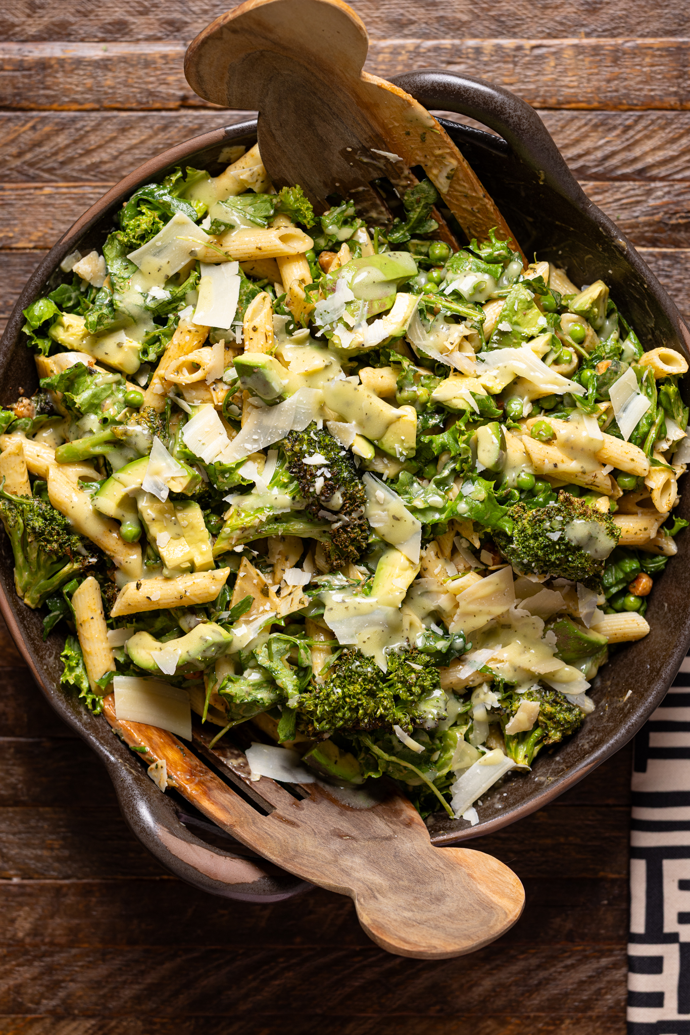 An image of green goddess salad in a bowl with serving forks.