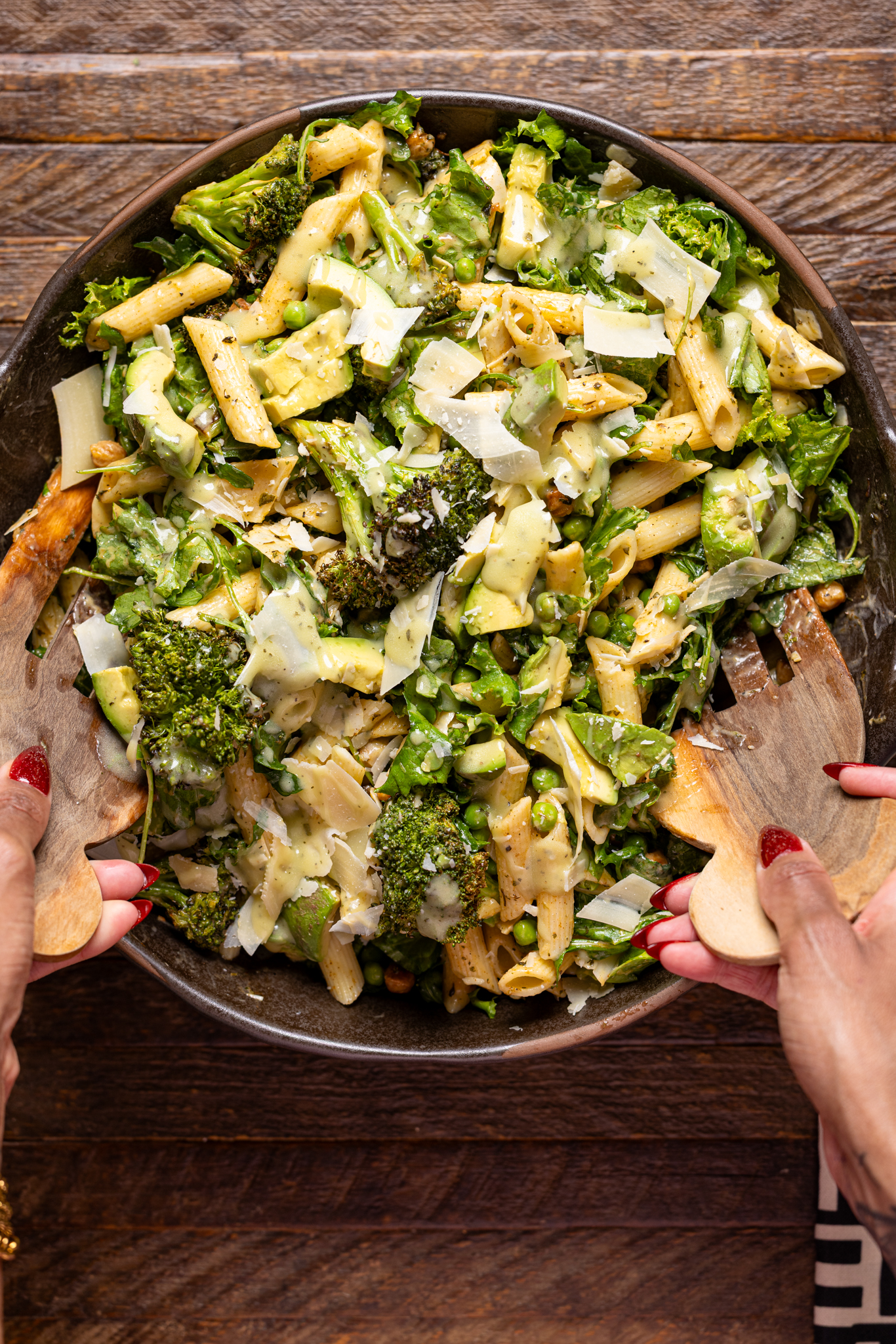 An image of green goddess in a bowl being tossed together.