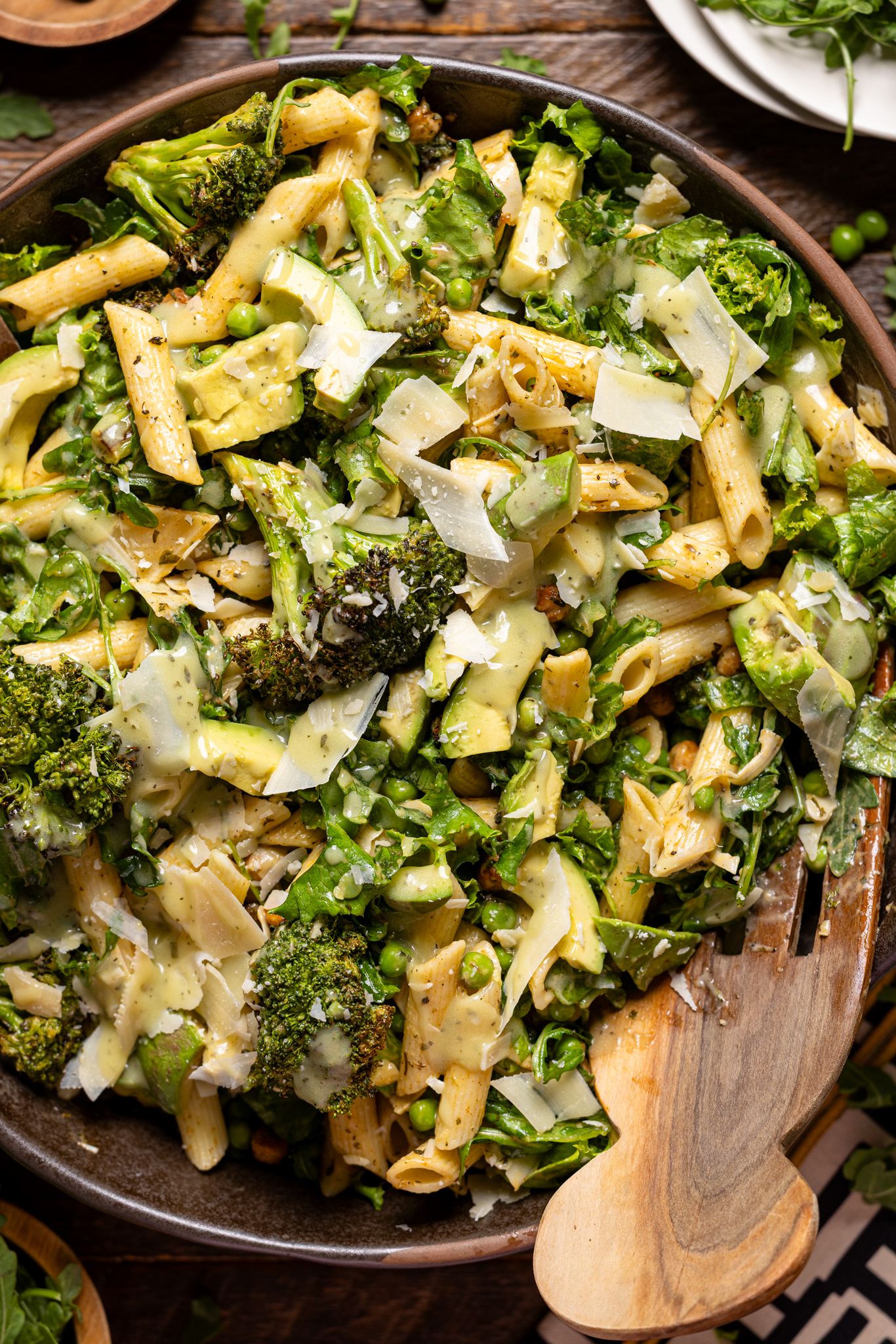 Up close shot of green goddess salad in a bowl with serving forks.