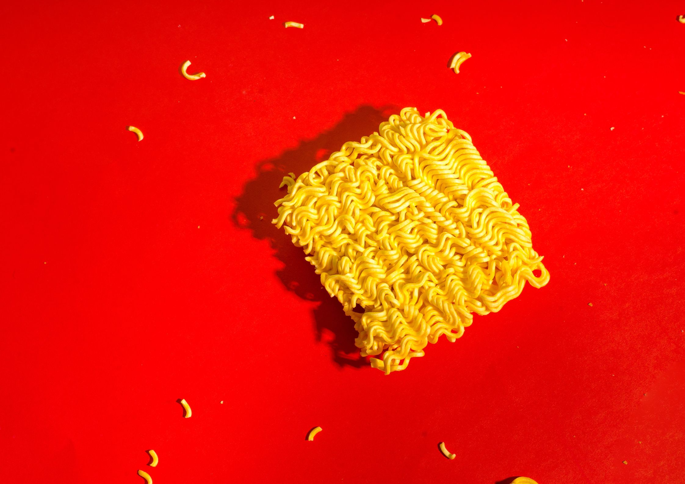Packet ramen noodles on red background