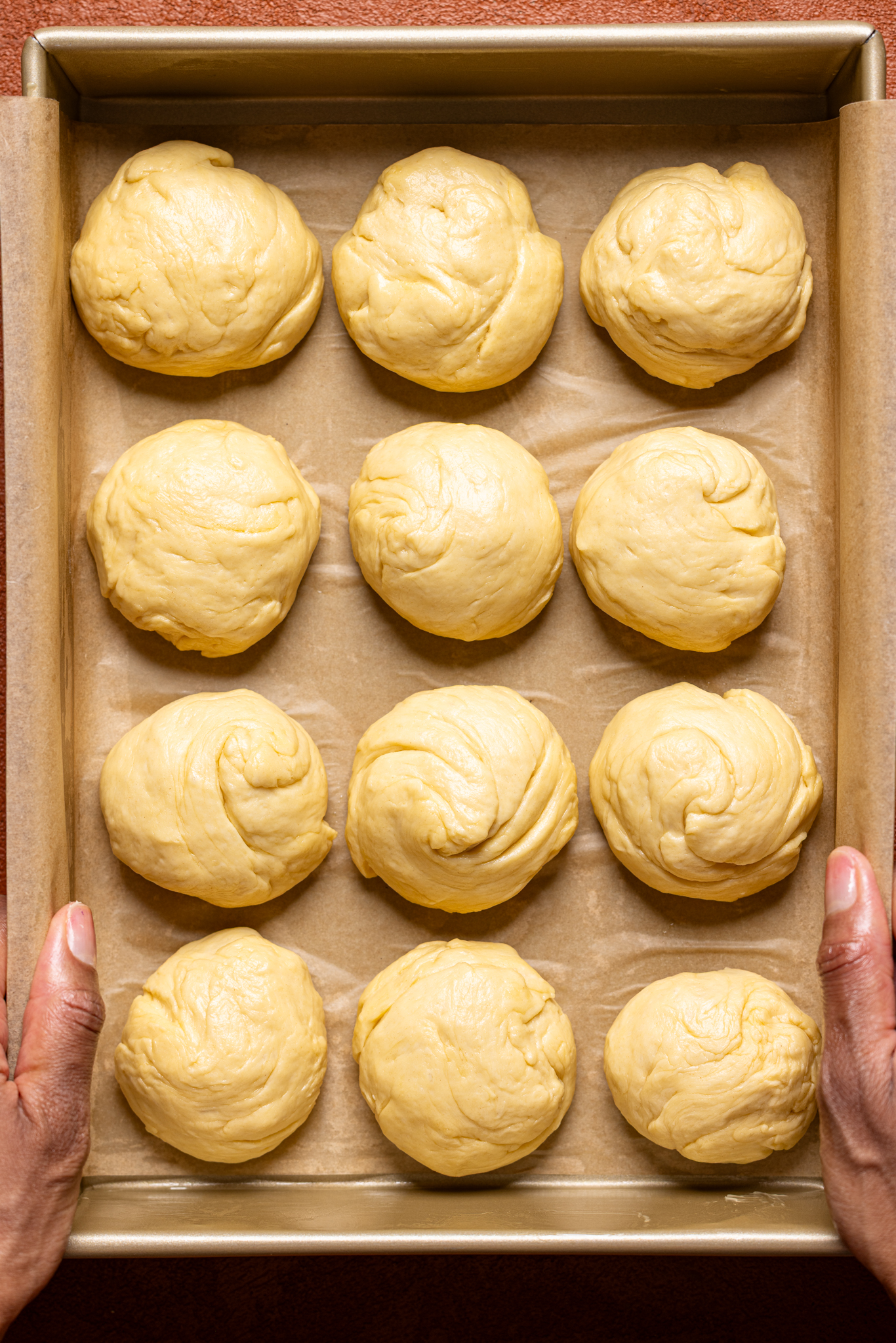 Round shaped dough in a baking dish in prep to bake.