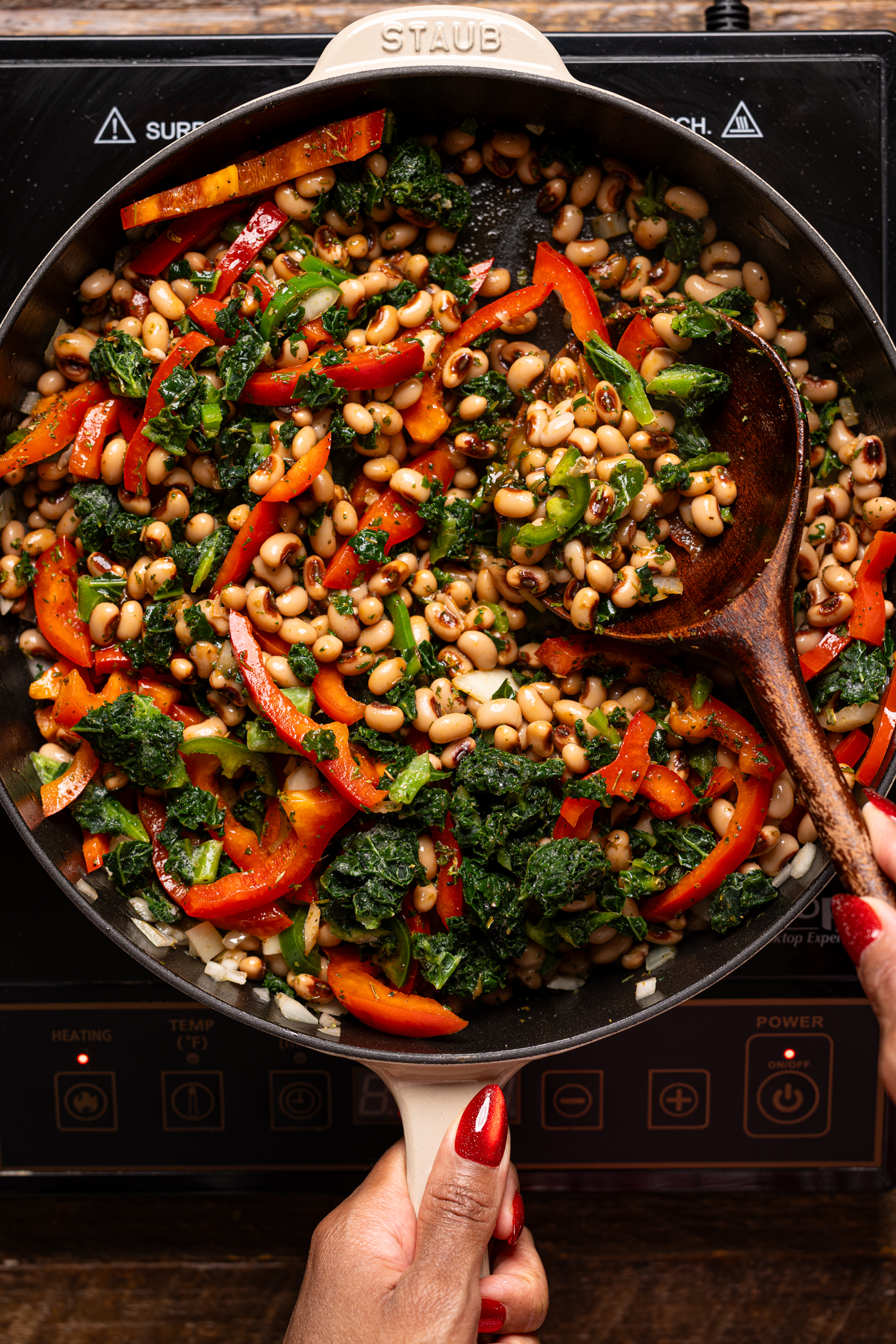 Image of ingredients being stirred together in a skillet over the stovetop.