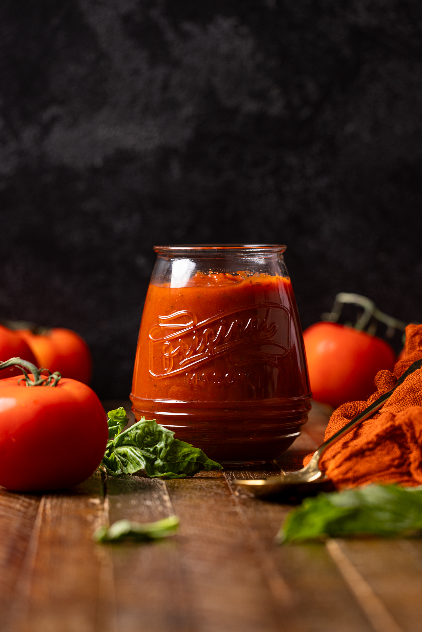 Image of pizza sauce in a jar with tomatoes.