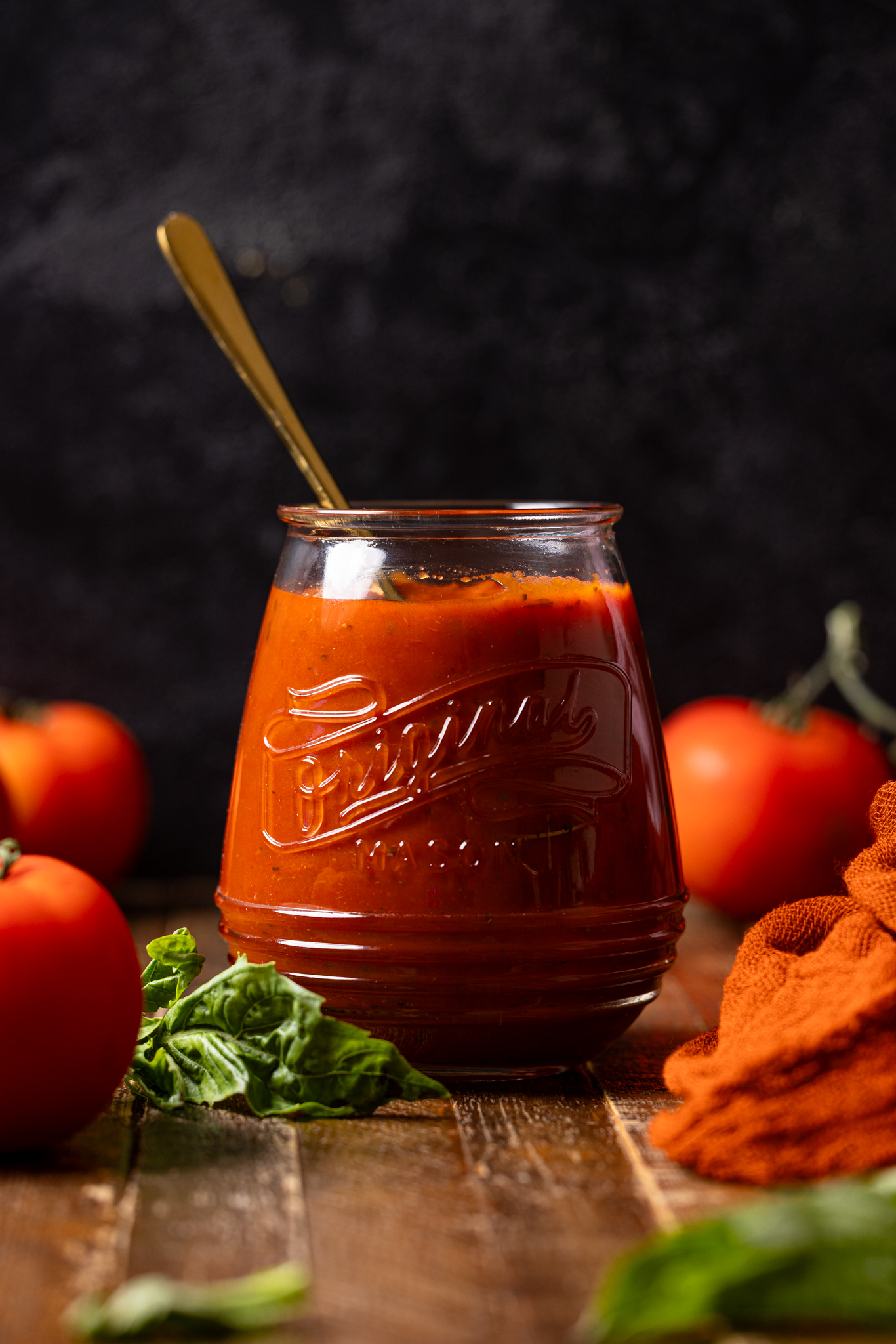 Image of up close of pizza sauce in a jar.