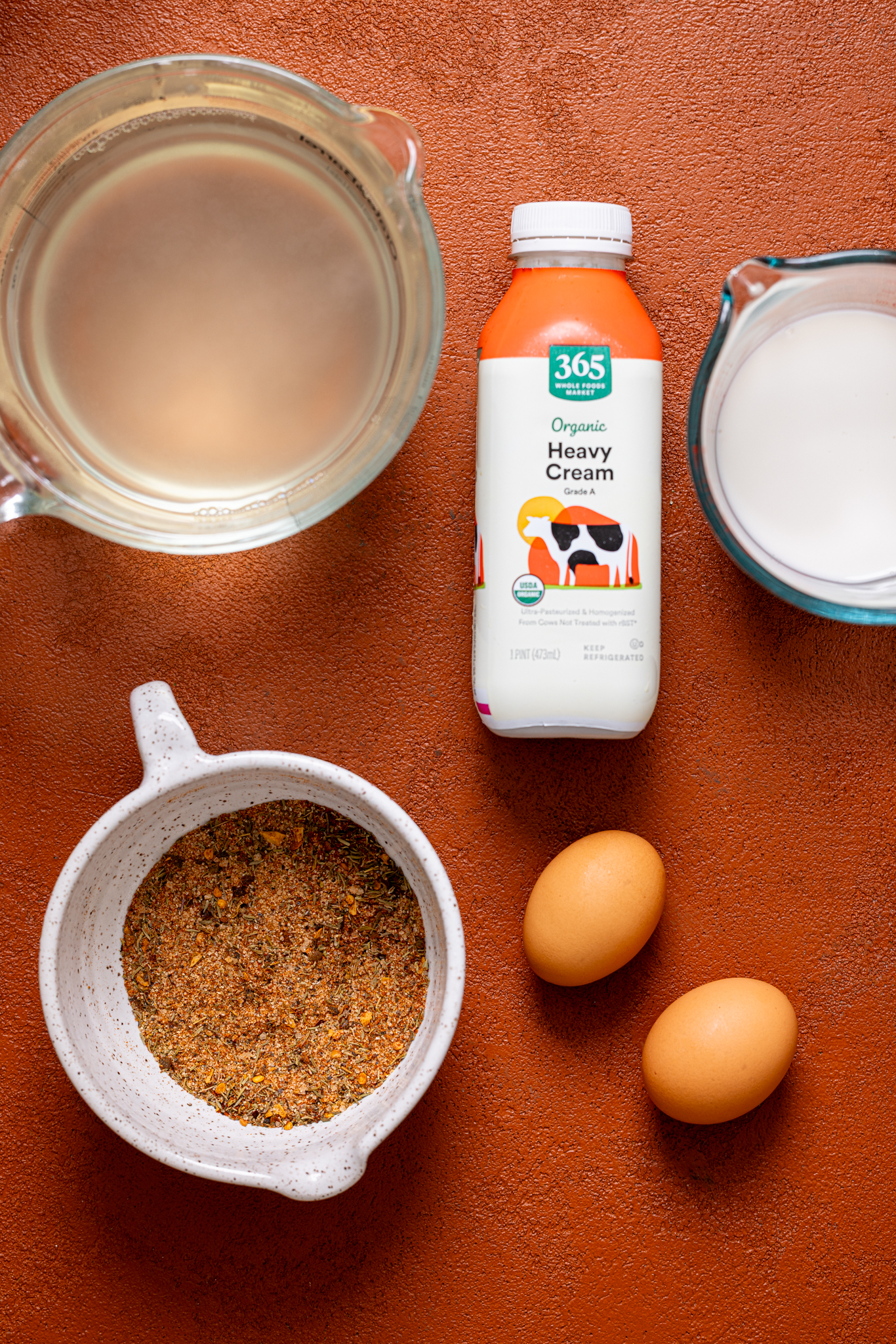 Ingredients on a burnt orange table.