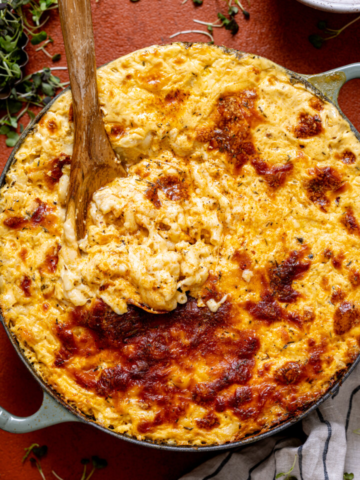 Creamy Baked Jerk Mac and Cheese in a green skillet.