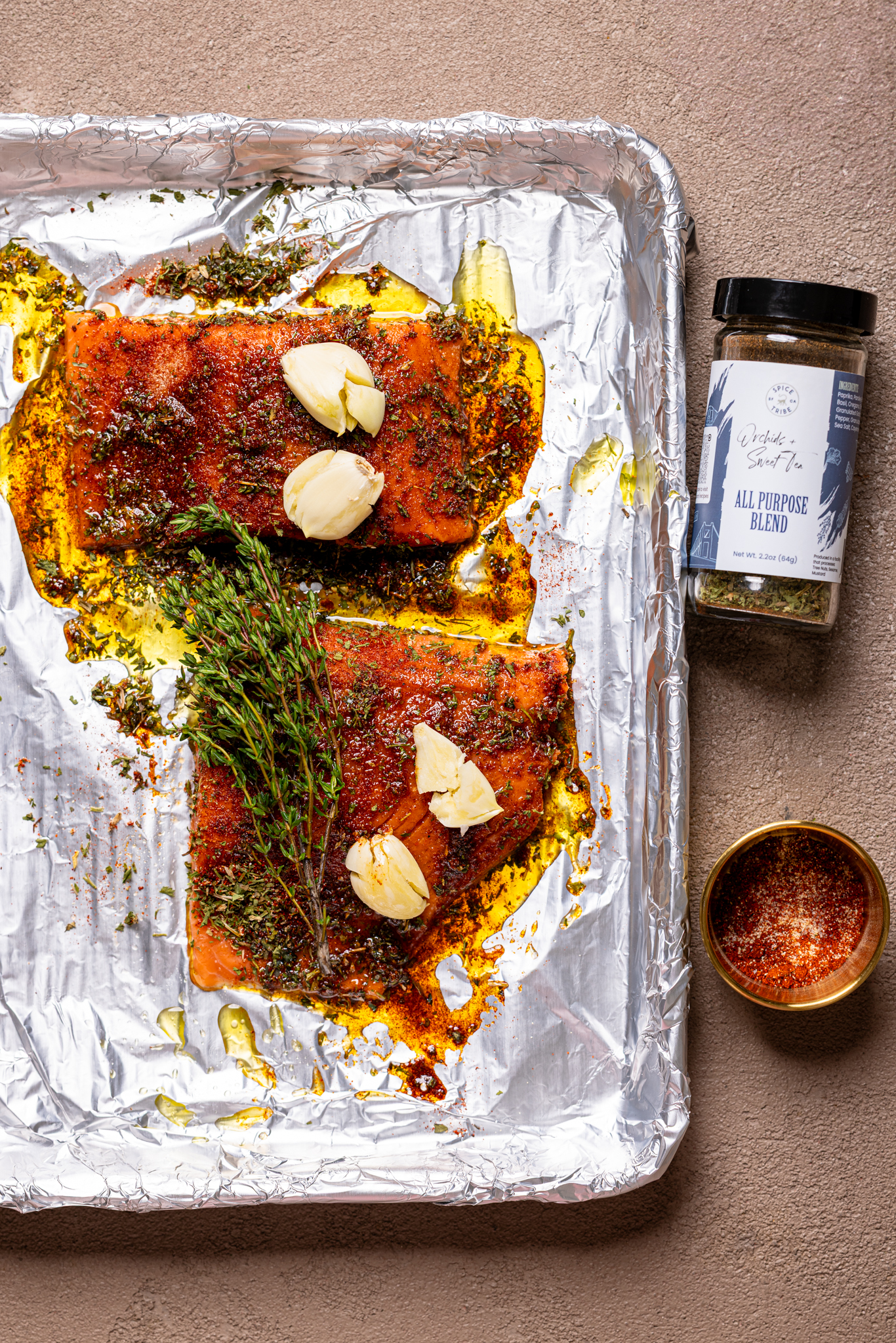 An image of marinated salmon on a baking sheet with foil paper.