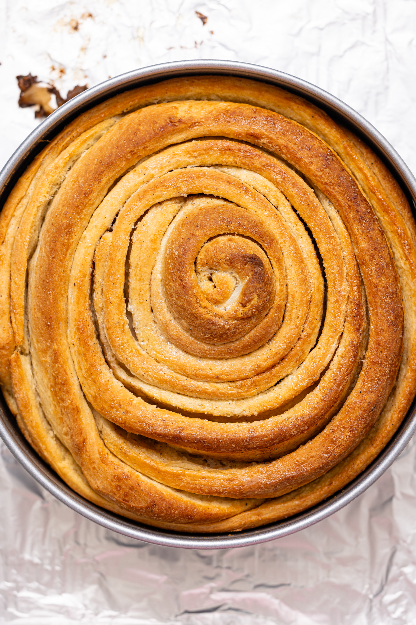 Baked giant cinnamon roll in a baking pan.