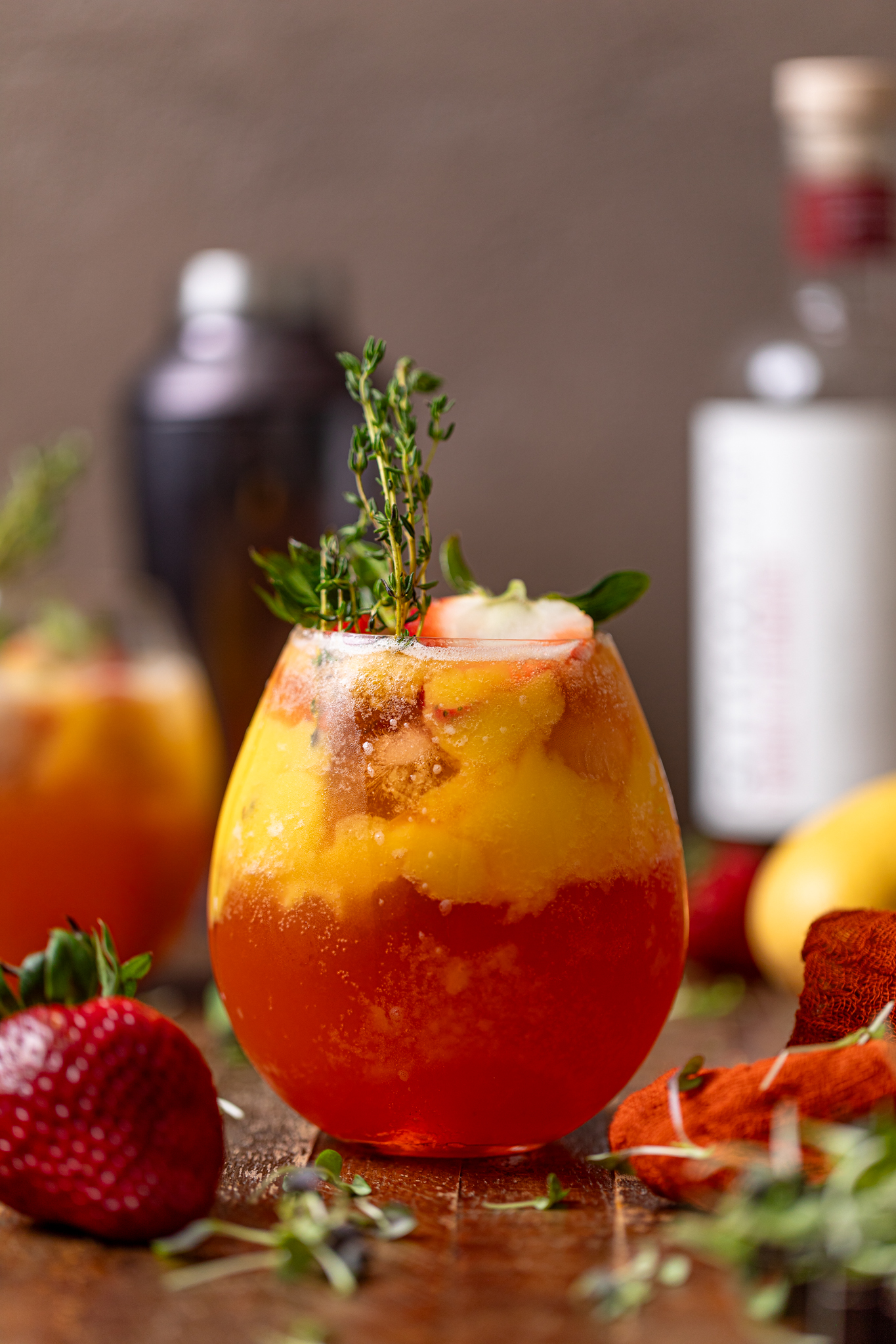 two glasses of Mango Strawberry Smash Mocktail with garnish.