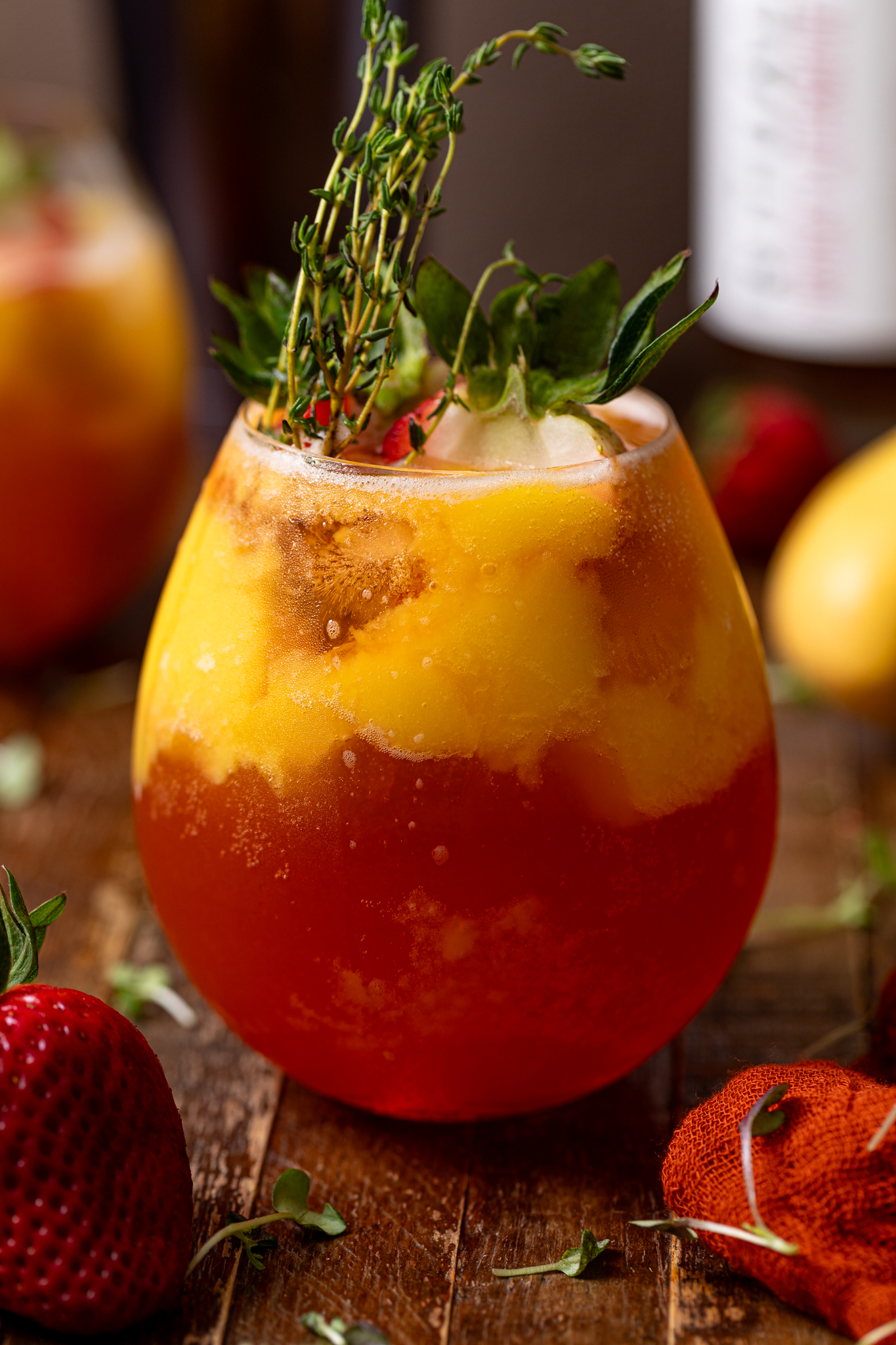 Up close shot of Mango Strawberry Smash Mocktail with strawberries and garnish. 