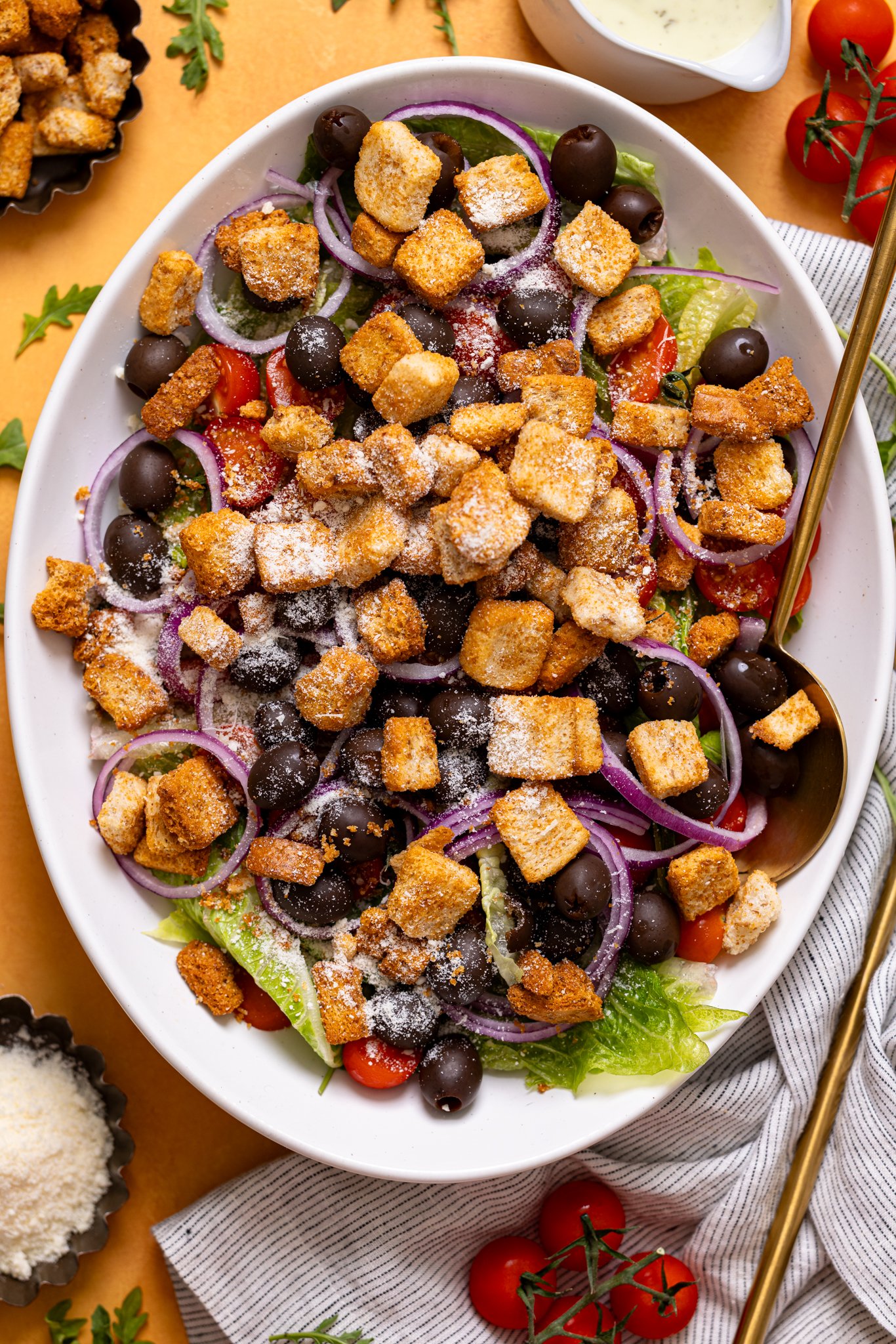 Copycat Olive Garden House Salad with Homemade Dressing on a platter with utensils.