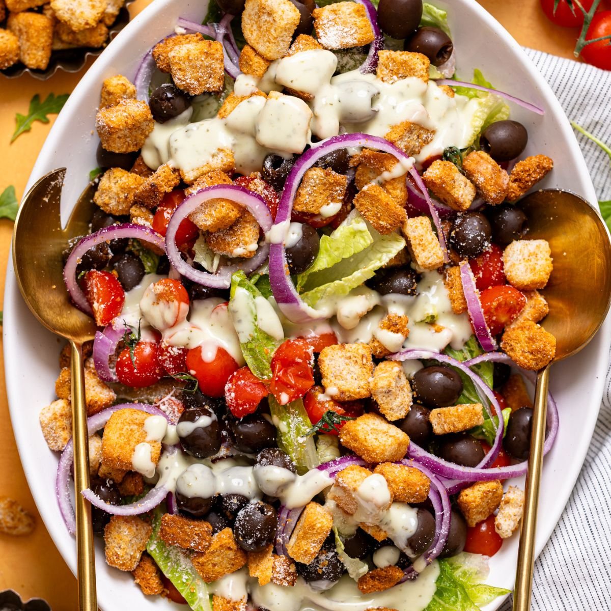 Copycat Olive Garden House Salad with Homemade Dressing on a white platter.