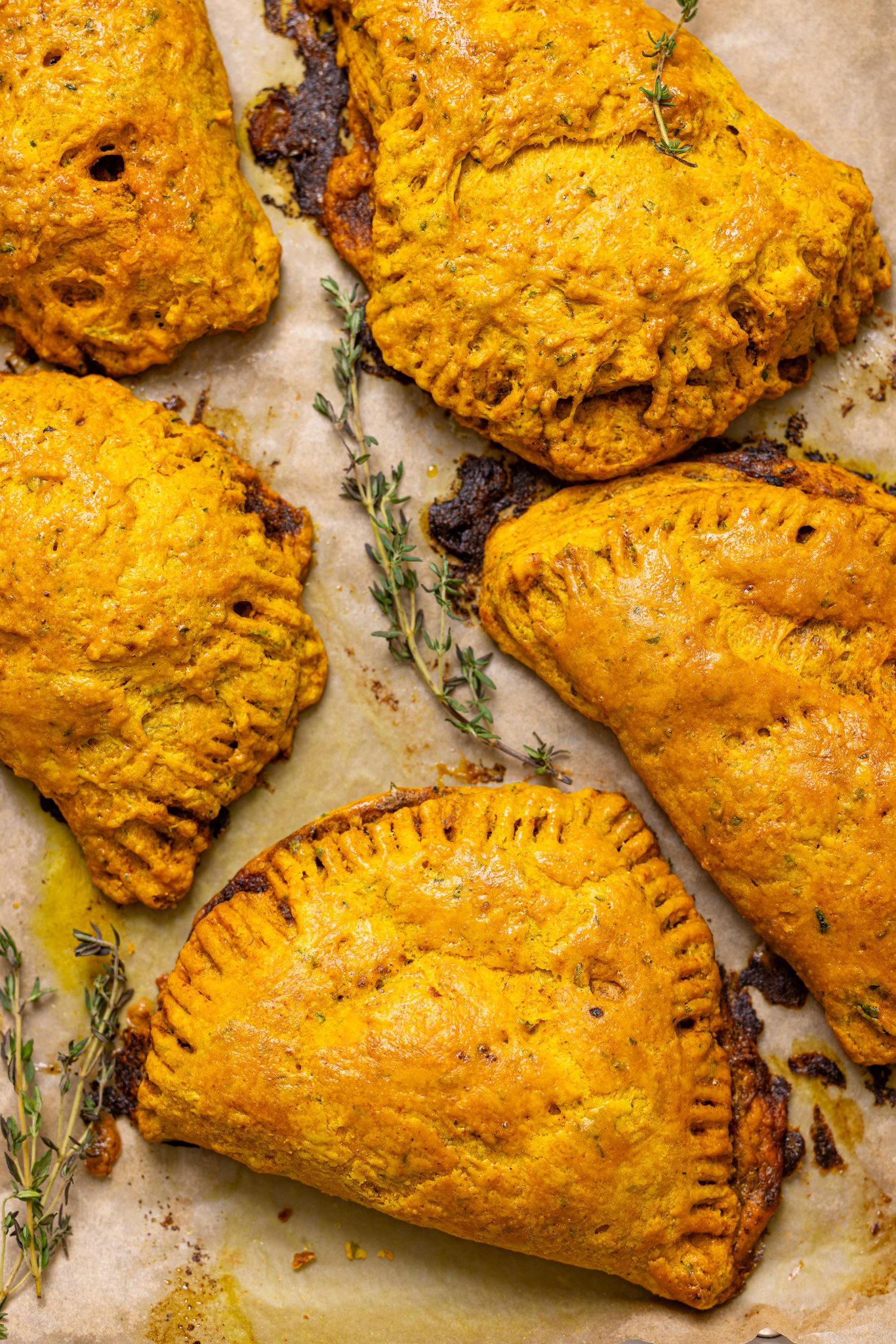 Image of Flaky Jamaican Curry Chicken Patties on a baking sheet. 